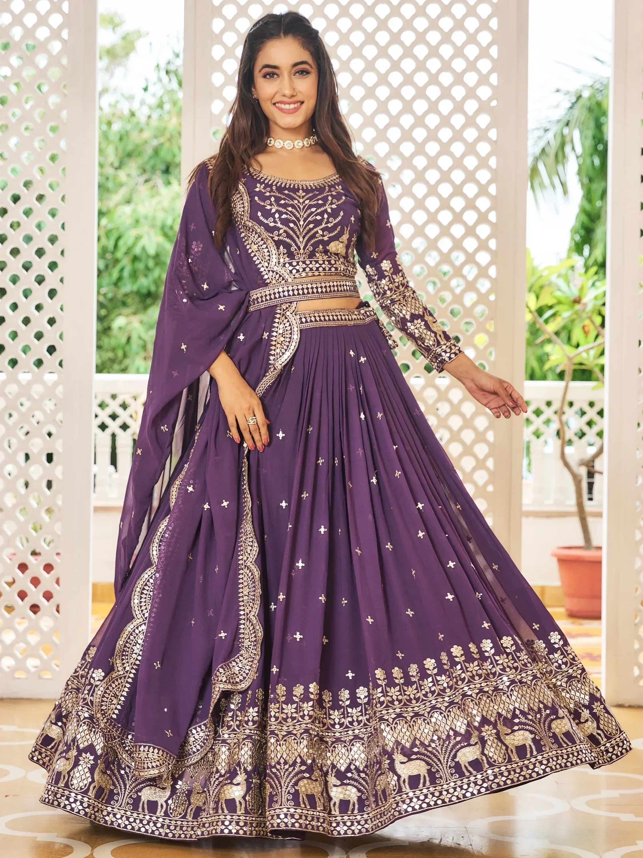Purple designer lehenga choli with gold embroidery and deer motifs, perfect for Indian ethnic wear events.
