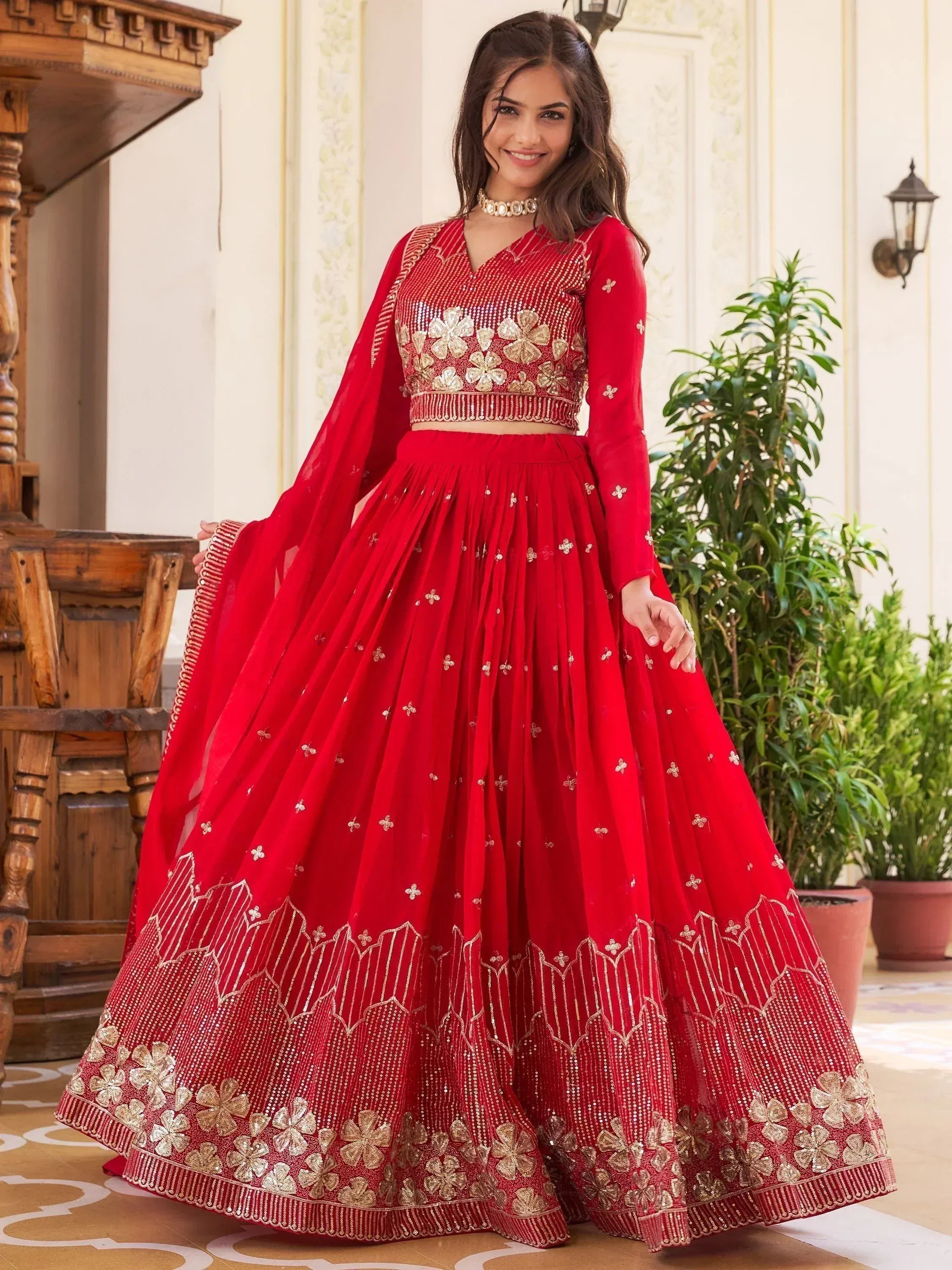 Red embroidered lehenga choli with gold floral work, perfect for Indian weddings and festive occasions
