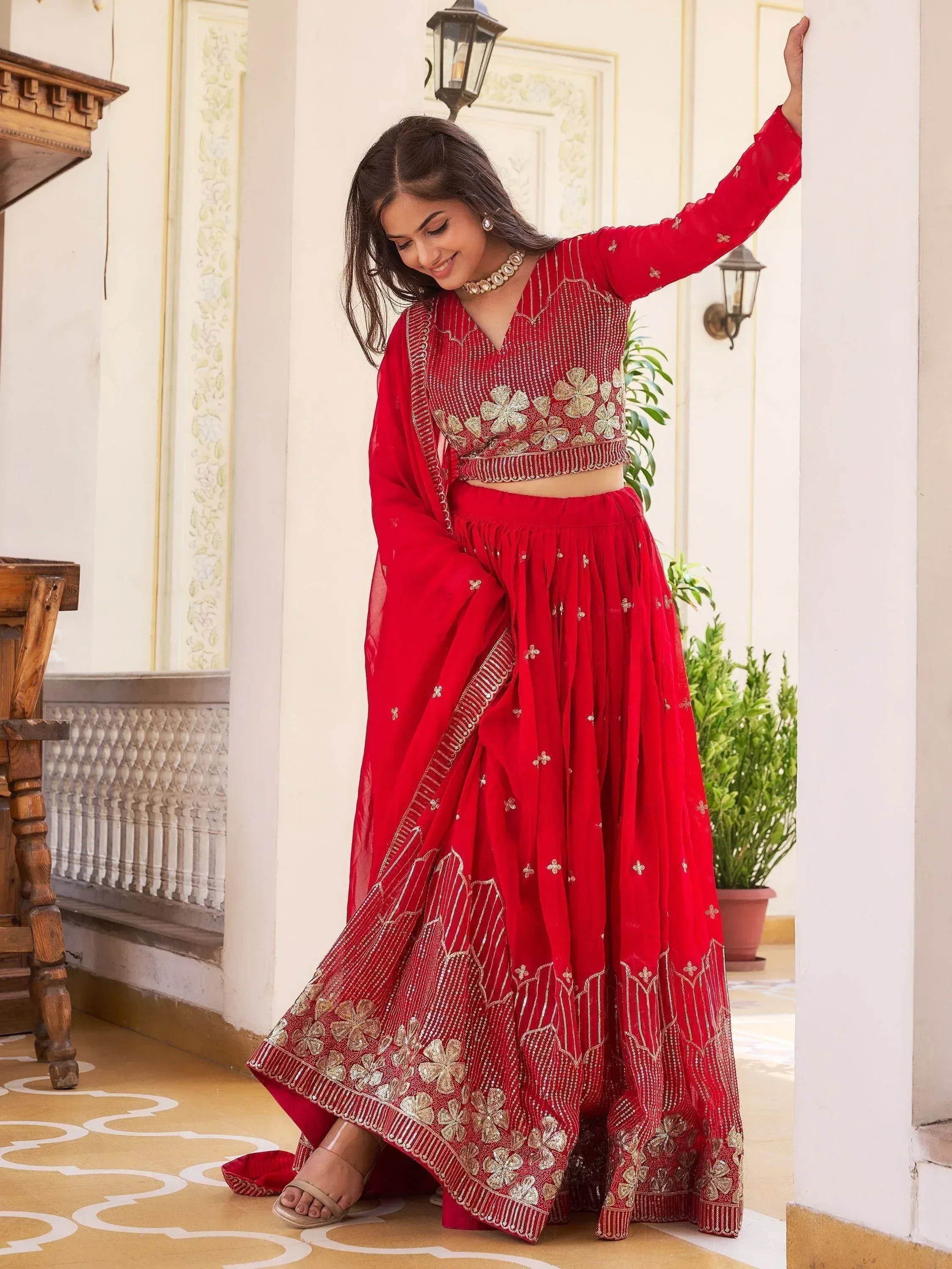 Red embroidered lehenga choli with gold floral work, perfect for Indian ethnic wear occasions