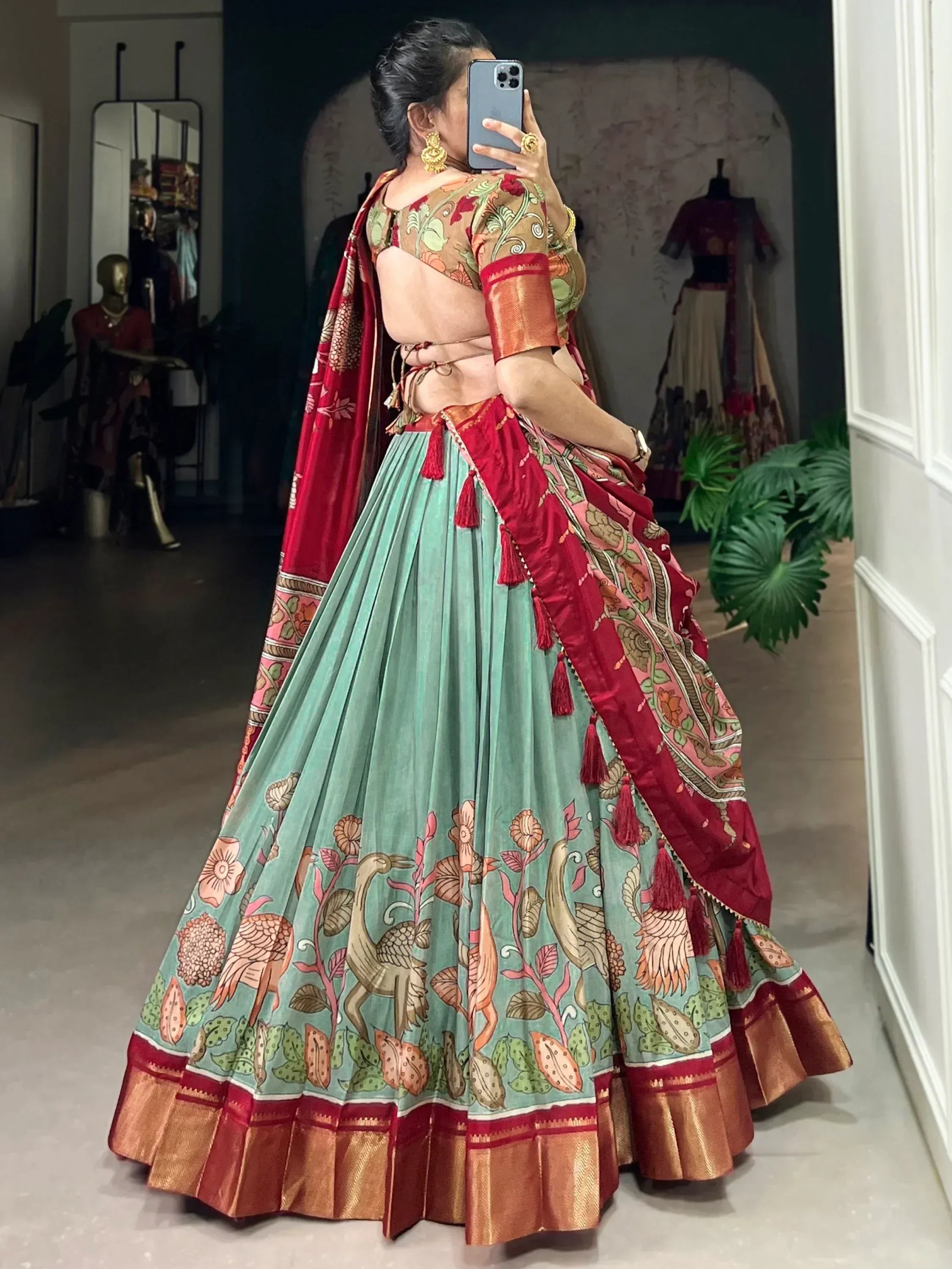 Woman in floral print lehenga choli with backless blouse and red dupatta, Indian ethnic wear