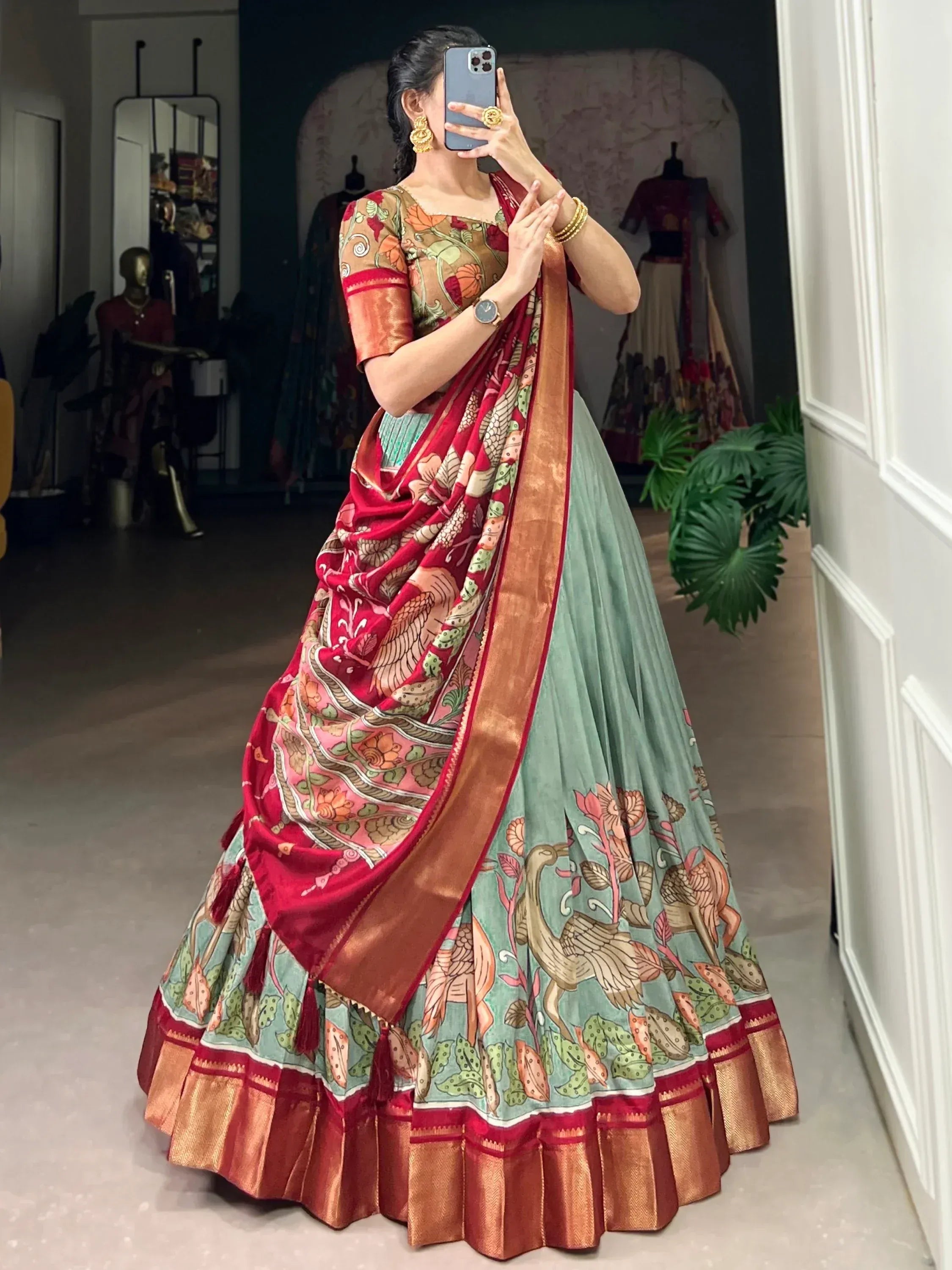 Woman in designer lehenga choli with floral and bird print, red dupatta, ethnic Indian wear