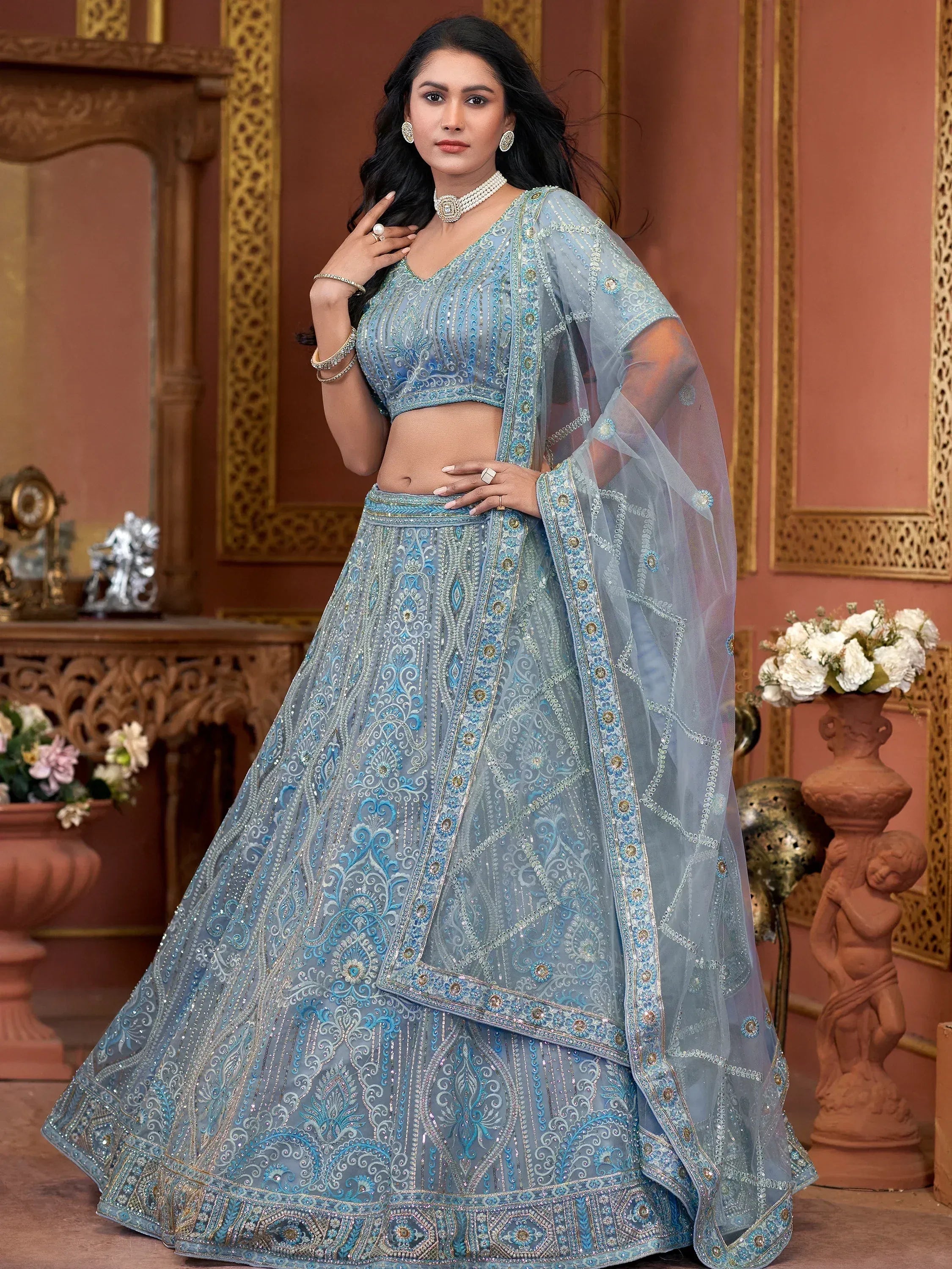 Elegant light blue designer lehenga choli with intricate embroidery and sheer dupatta for Indian ethnic wear