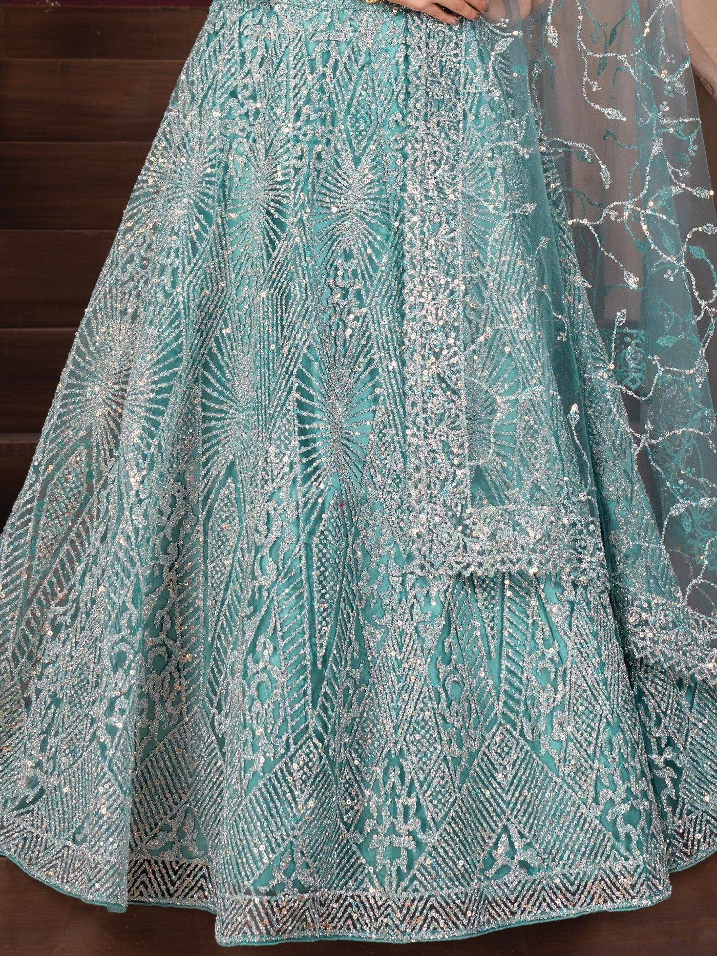 Teal designer lehenga with intricate silver embroidery and sequin work, perfect for Indian ethnic wear.
