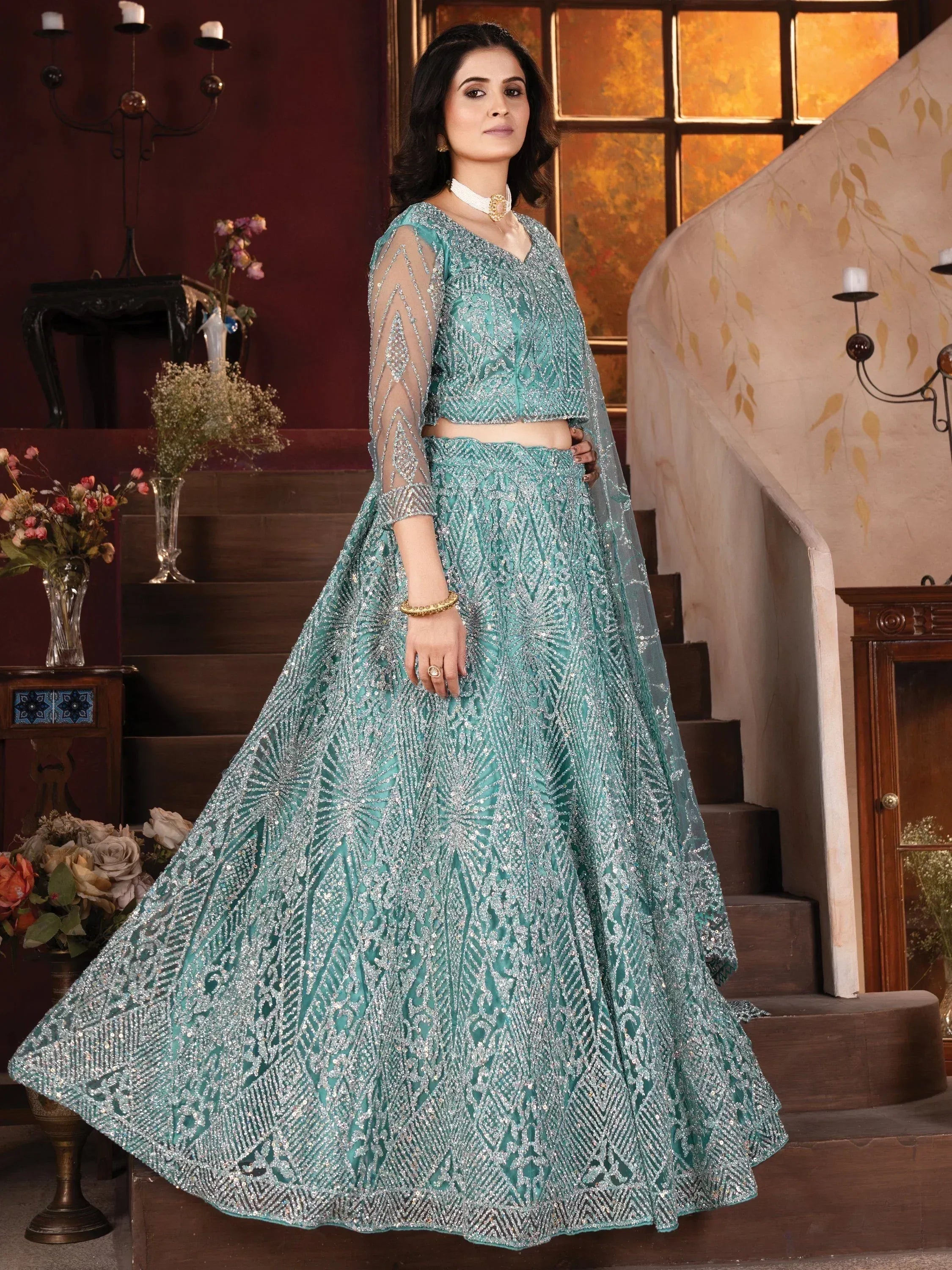 Teal designer lehenga choli with silver embroidery, perfect for Indian weddings and festive occasions.
