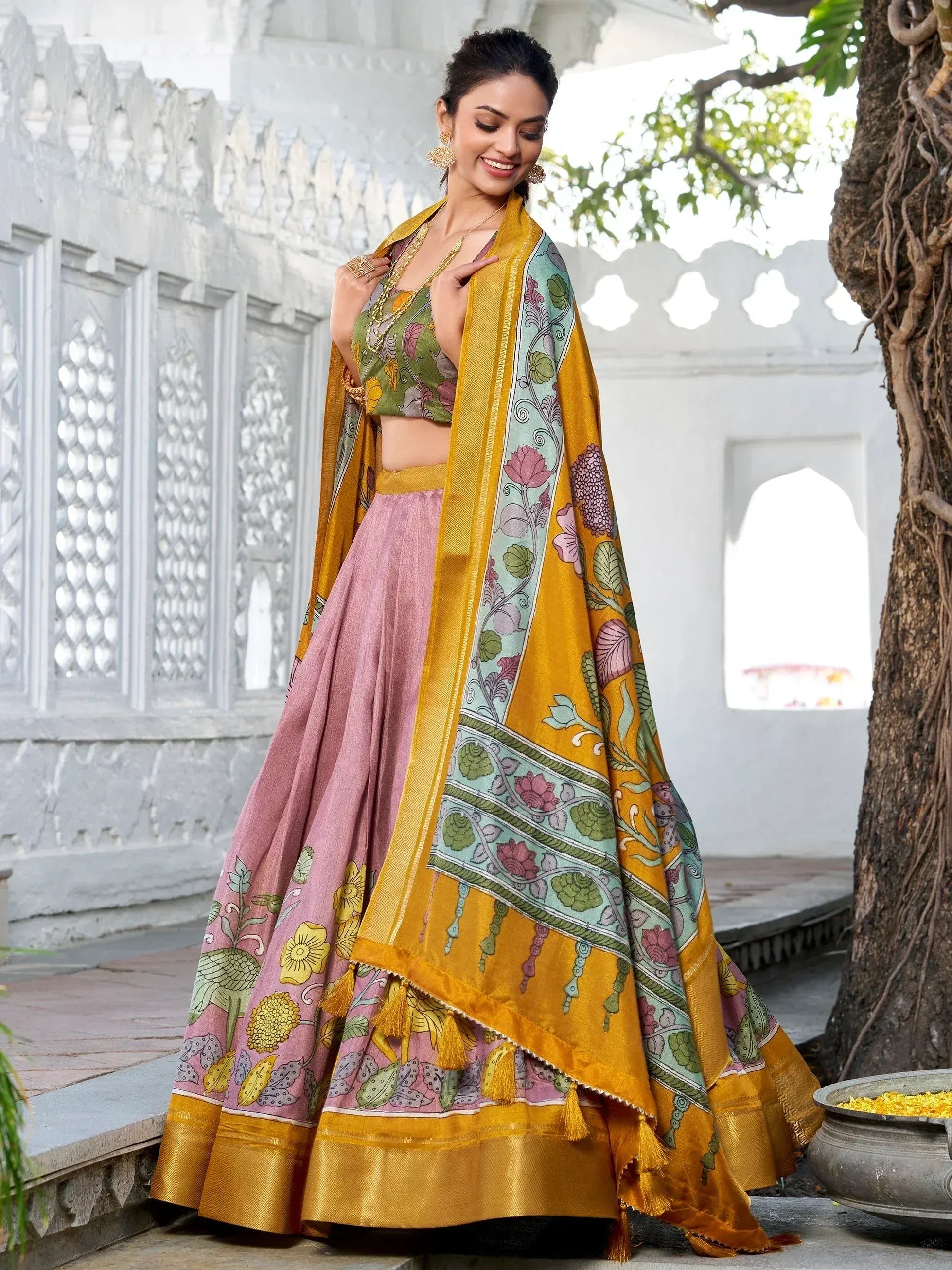 Woman in floral print lehenga choli with yellow dupatta, ethnic Indian wear for festive occasions