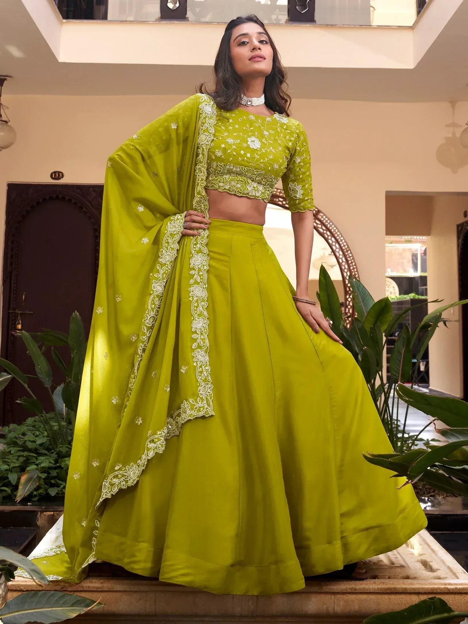Vibrant green lehenga choli with white floral embroidery, perfect for Indian ethnic wear occasions
