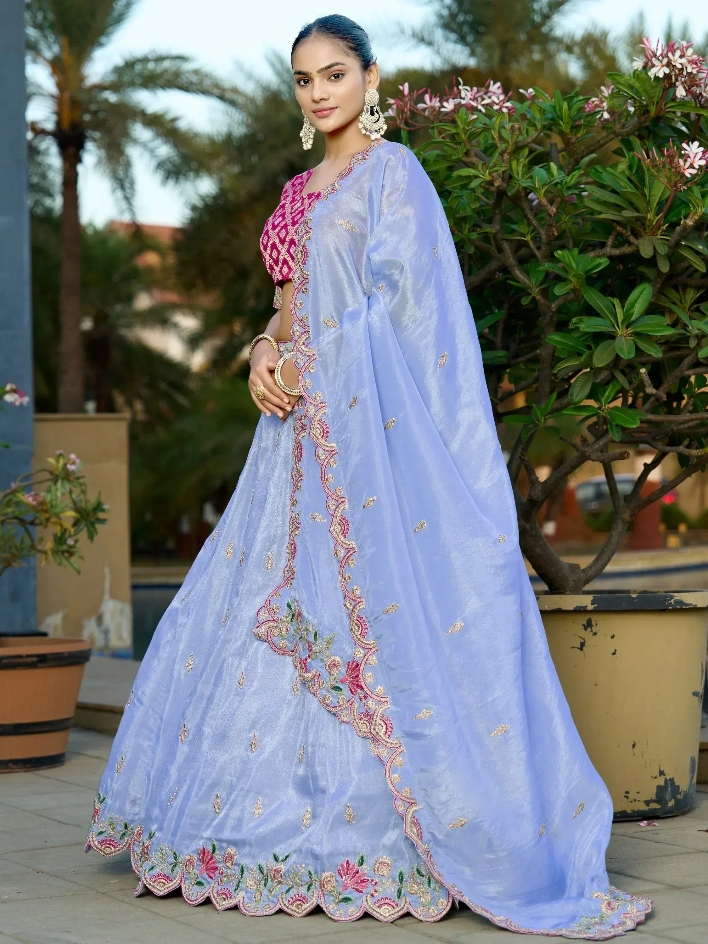 Light blue embroidered lehenga choli with pink blouse, perfect for Indian weddings and festive occasions.