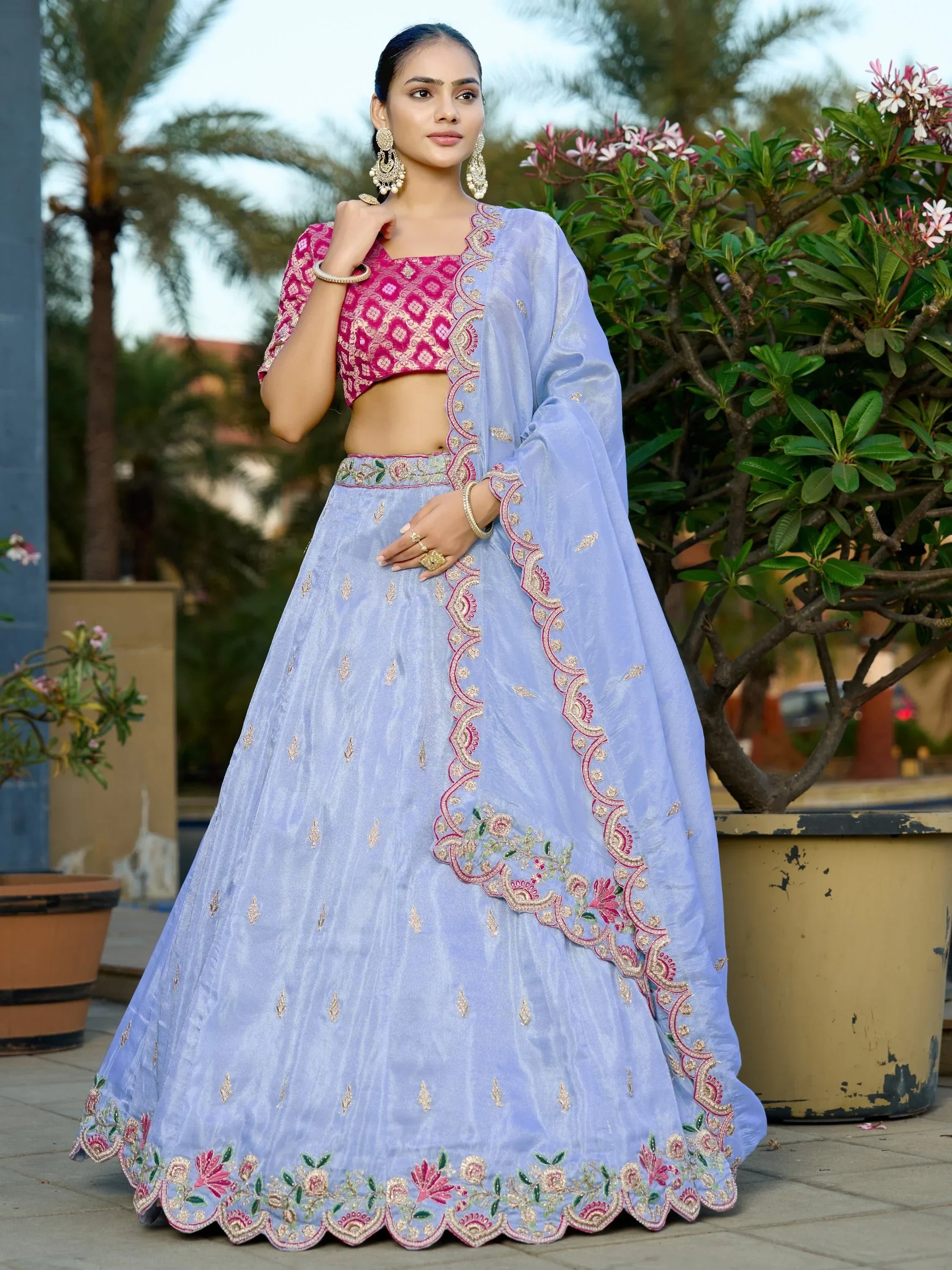 Light blue embroidered lehenga choli with pink blouse, perfect for Indian ethnic occasions and weddings.