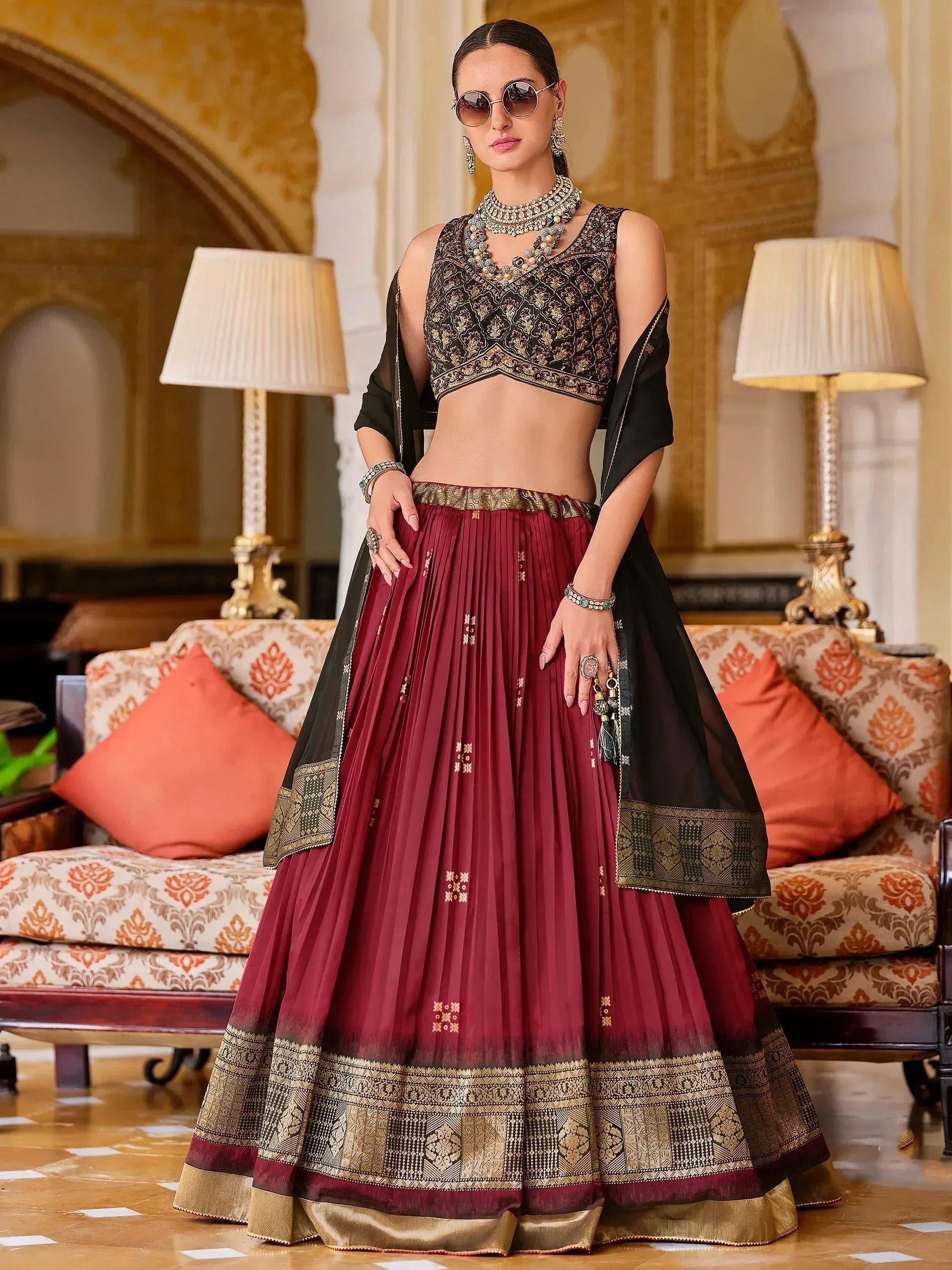 Maroon and black designer lehenga choli with gold embroidery, perfect for Indian ethnic wear occasions.