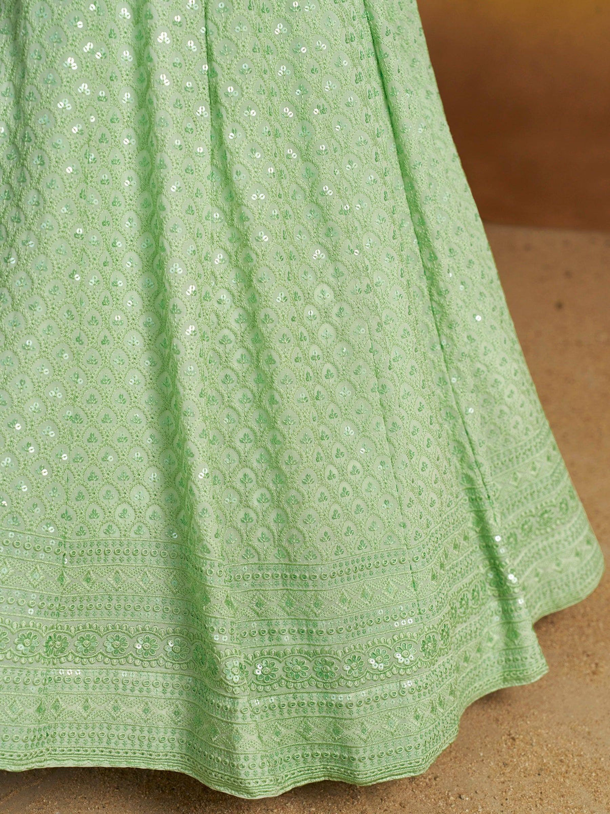 Mint green ethnic gown with floral embroidery and sequin detailing, perfect for Indian occasions