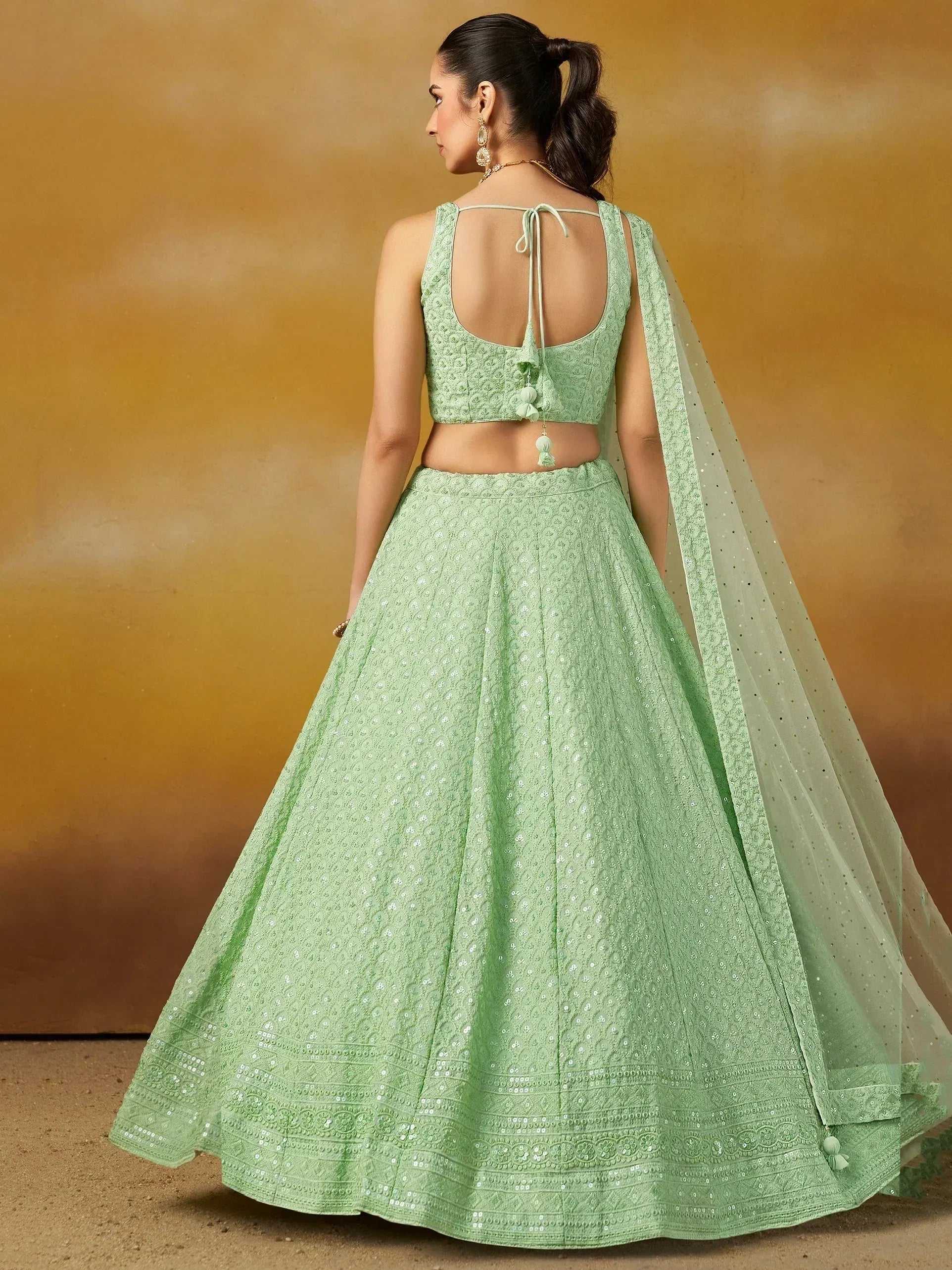 Mint green embroidered lehenga choli with back tie blouse and sheer dupatta, perfect for Indian ethnic occasions