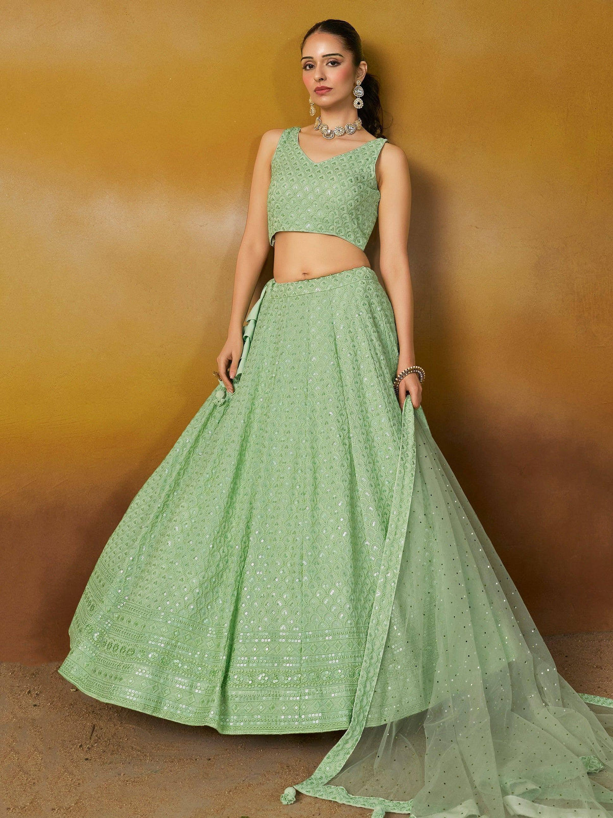 Mint green sequined lehenga choli with sheer dupatta, perfect for Indian ethnic wear and festive occasions.