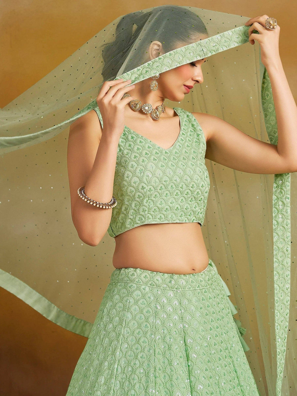 Mint green embroidered lehenga choli with sheer dupatta, perfect for Indian ethnic wear and festive occasions.