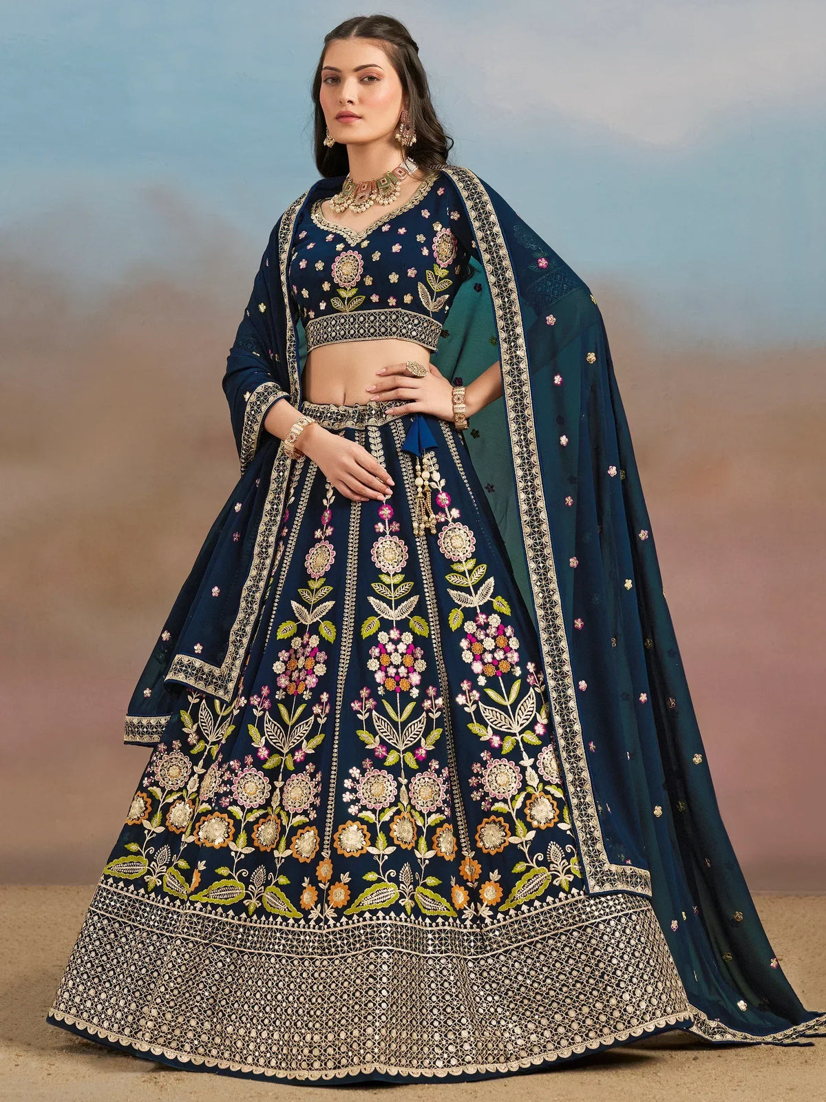 Navy blue embroidered lehenga choli with floral motifs and gold detailing, perfect for Indian ethnic wear