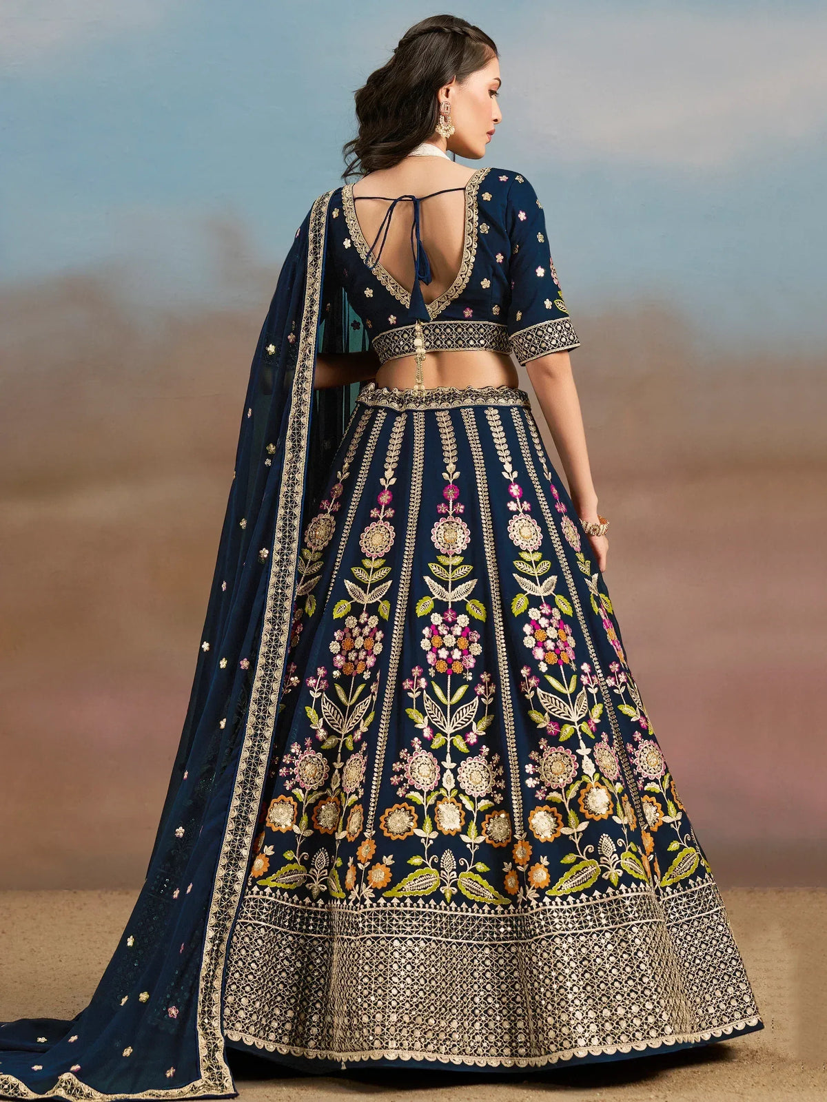 Navy blue embroidered lehenga choli with floral motifs and open back blouse, perfect for Indian weddings