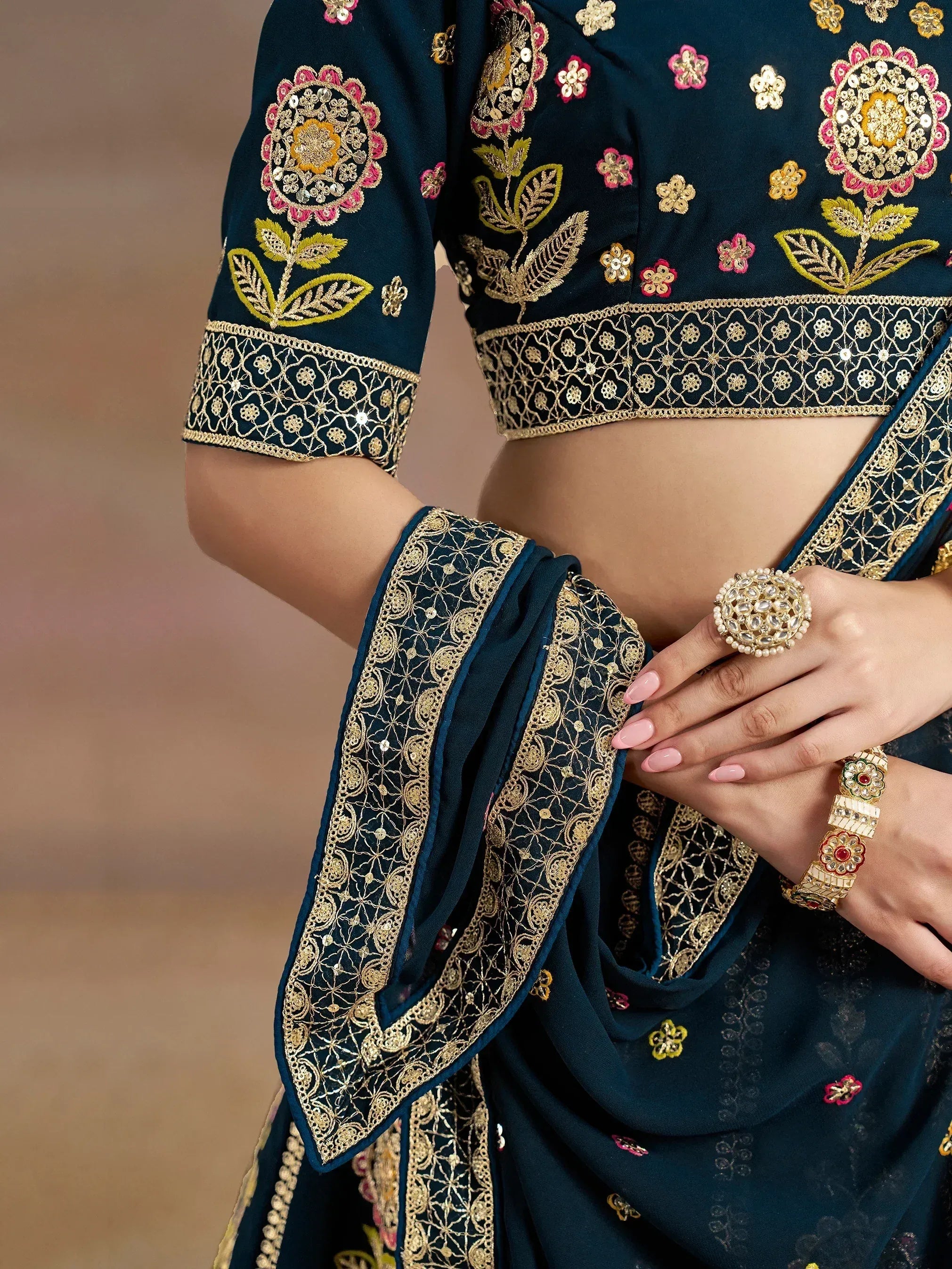 Dark blue embroidered lehenga choli with gold floral motifs and intricate border detailing