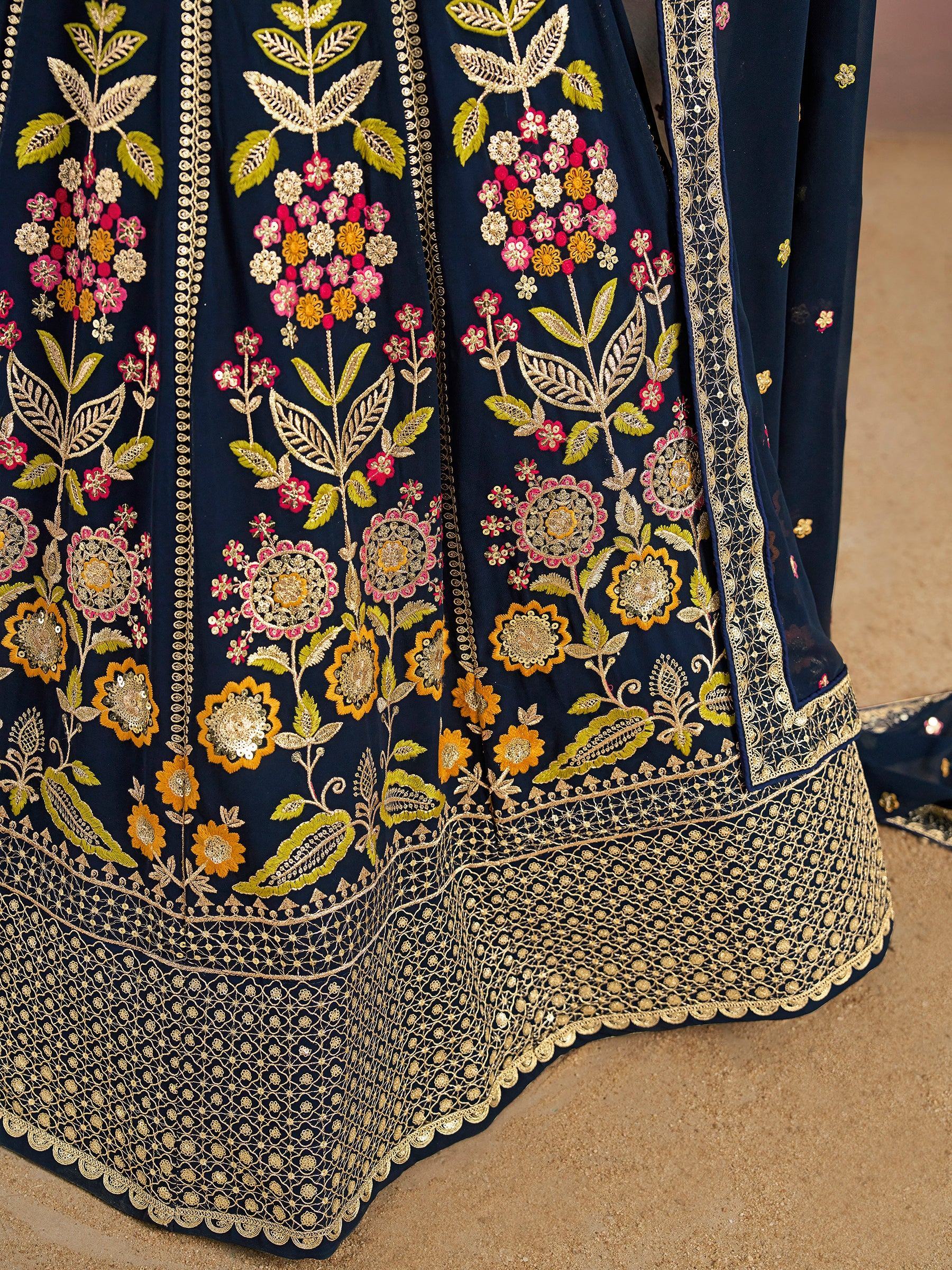 Navy blue lehenga with gold, pink, and yellow floral embroidery and intricate border detailing