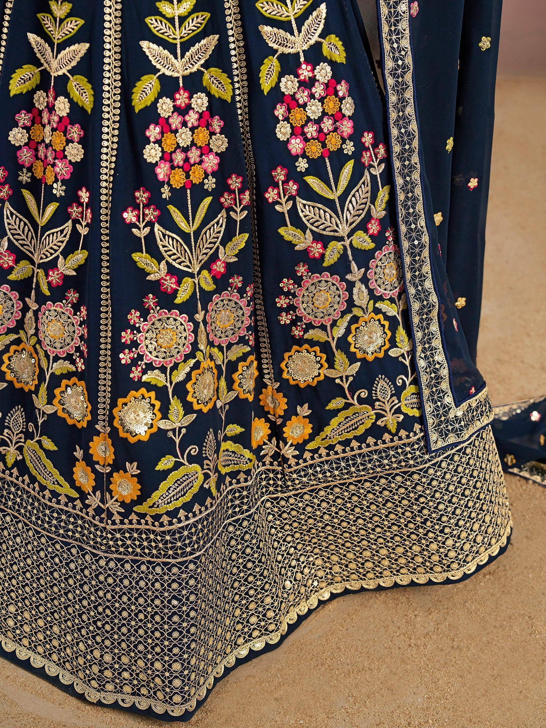 Navy blue lehenga with gold, pink, and yellow floral embroidery and intricate border detailing