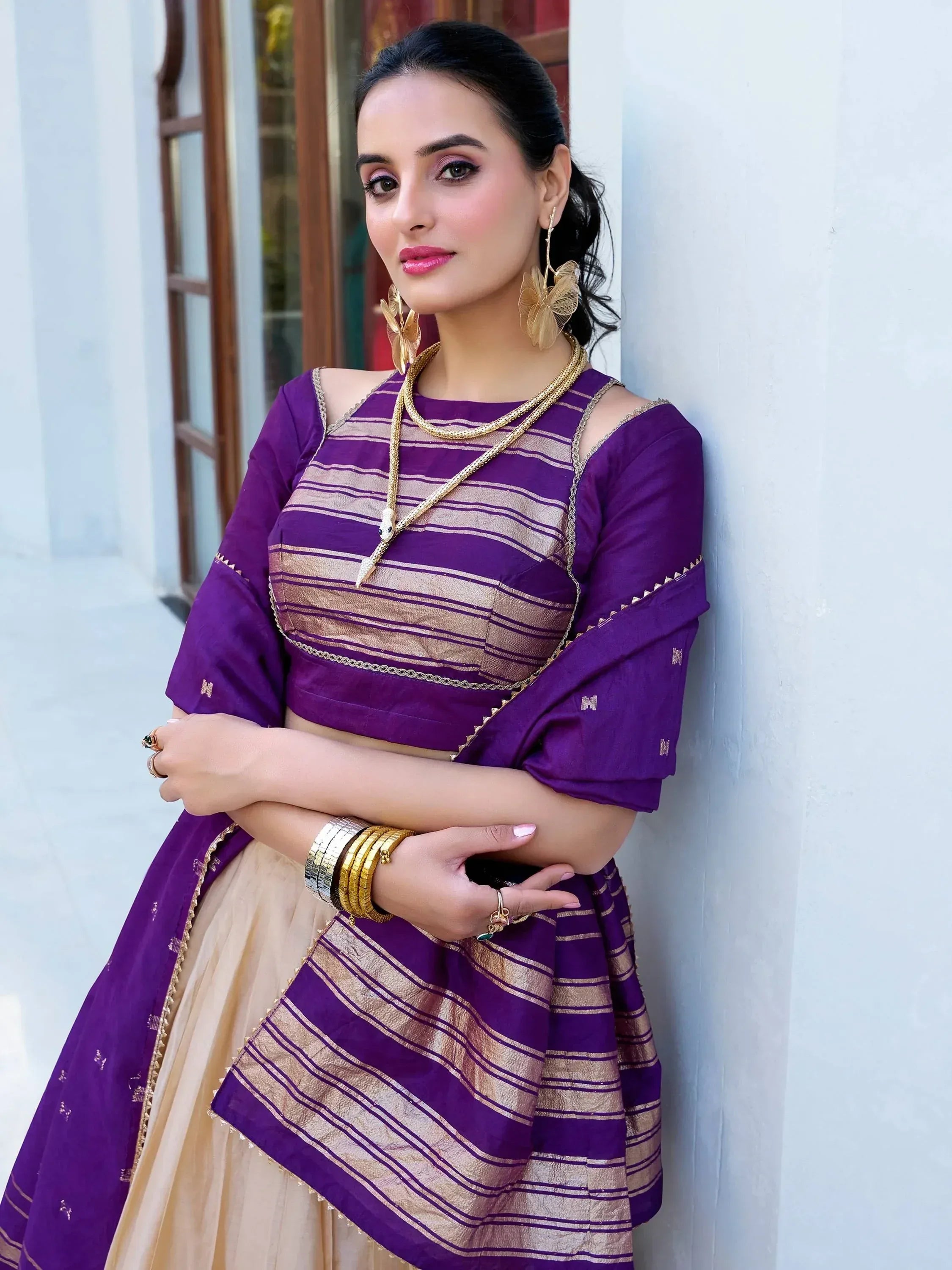 Purple and gold striped lehenga choli with cold shoulder top, perfect for Indian ethnic occasions