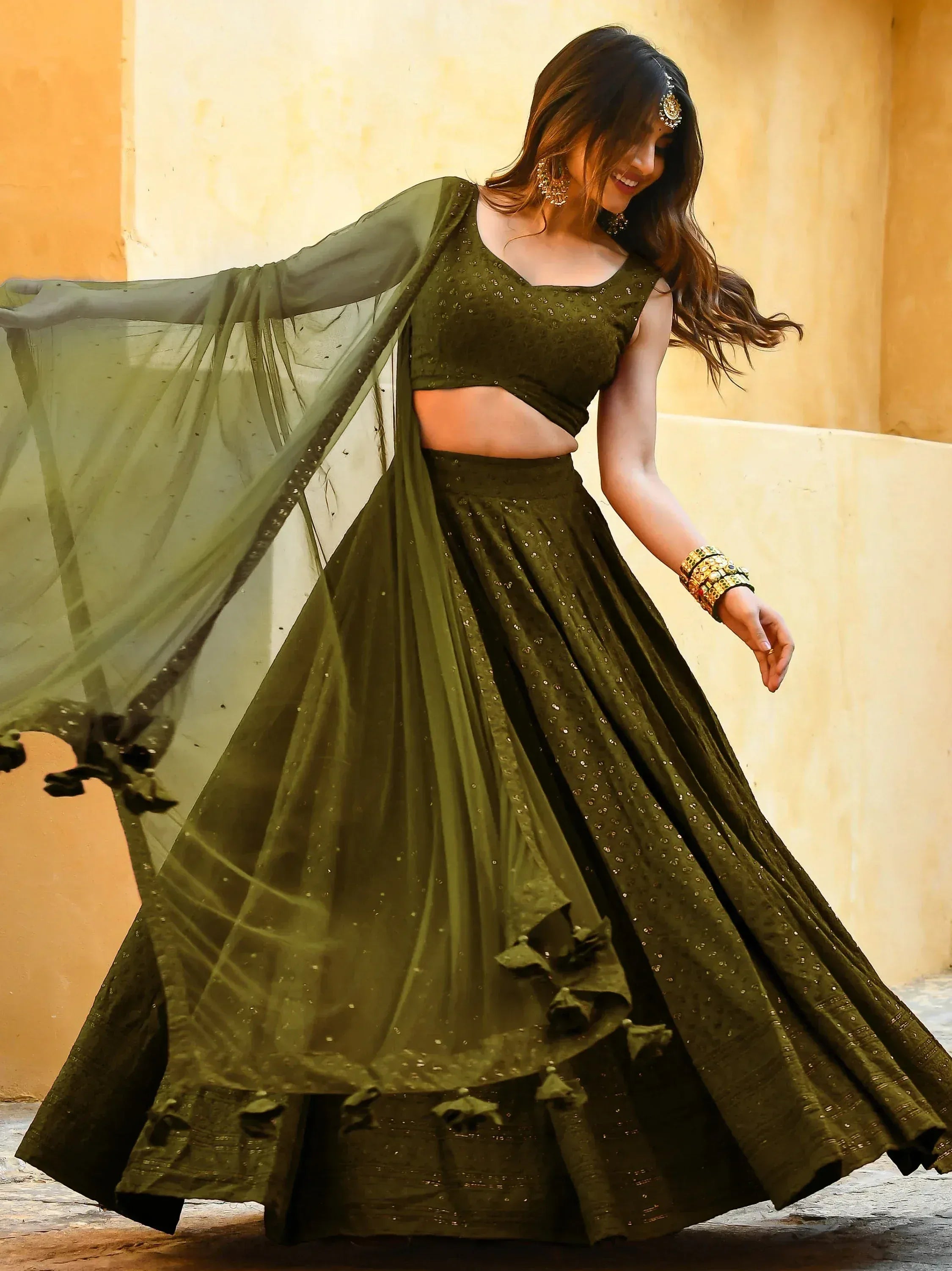 Olive green designer lehenga choli with sequins, sheer dupatta, and ruffled skirt for Indian ethnic wear