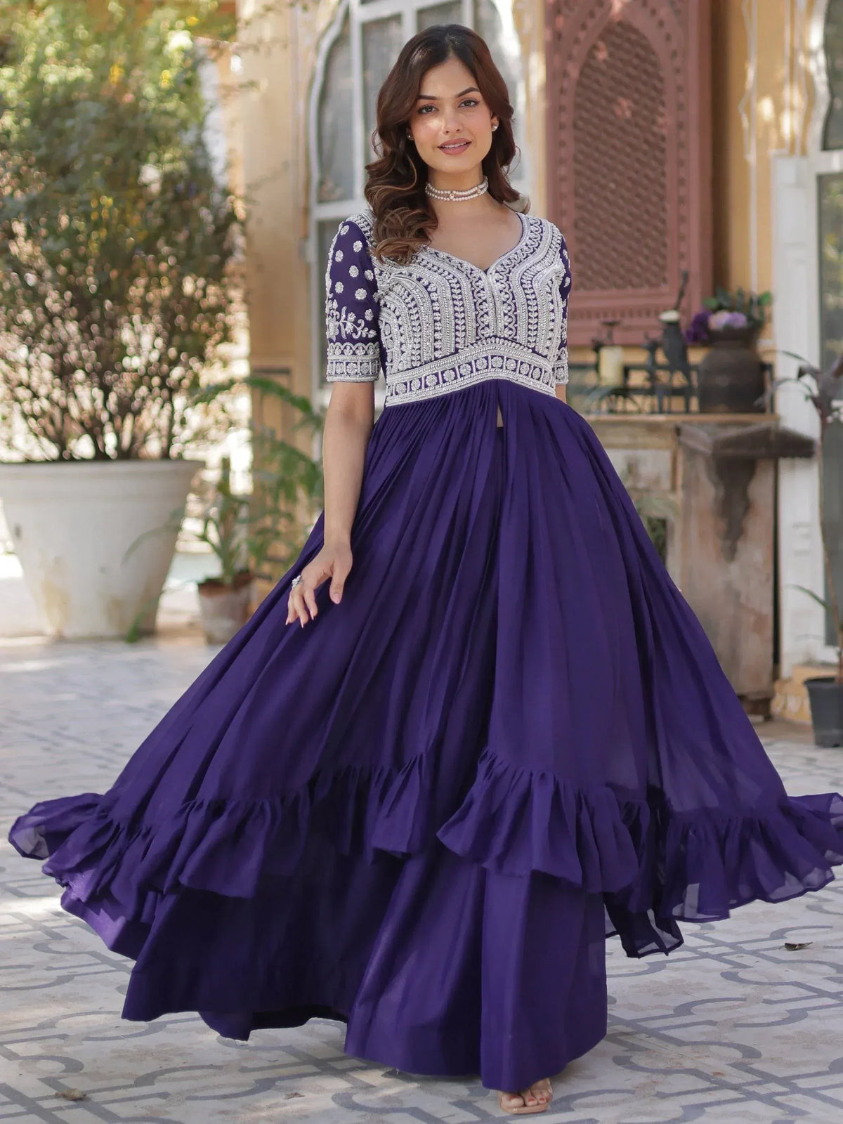 Purple embroidered ethnic gown with ruffled skirt, perfect for Indian occasions and festive wear.