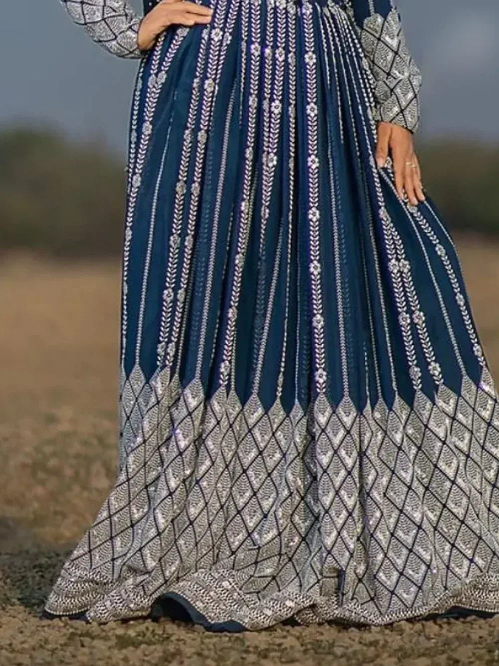 Navy blue ethnic gown with silver embroidery and geometric border, perfect for Indian occasions