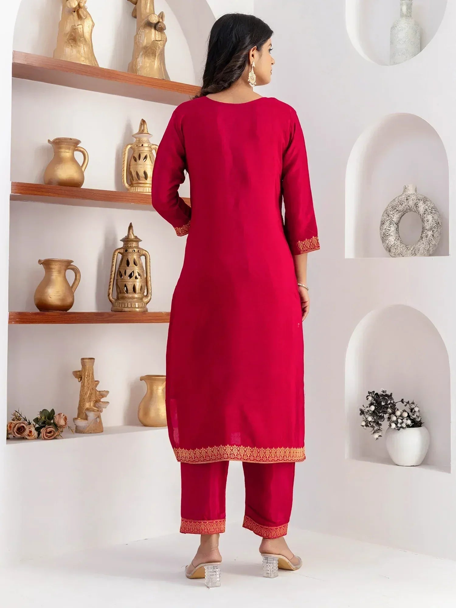 Red ethnic kurta with gold embroidery paired with matching pants, styled for Indian wear