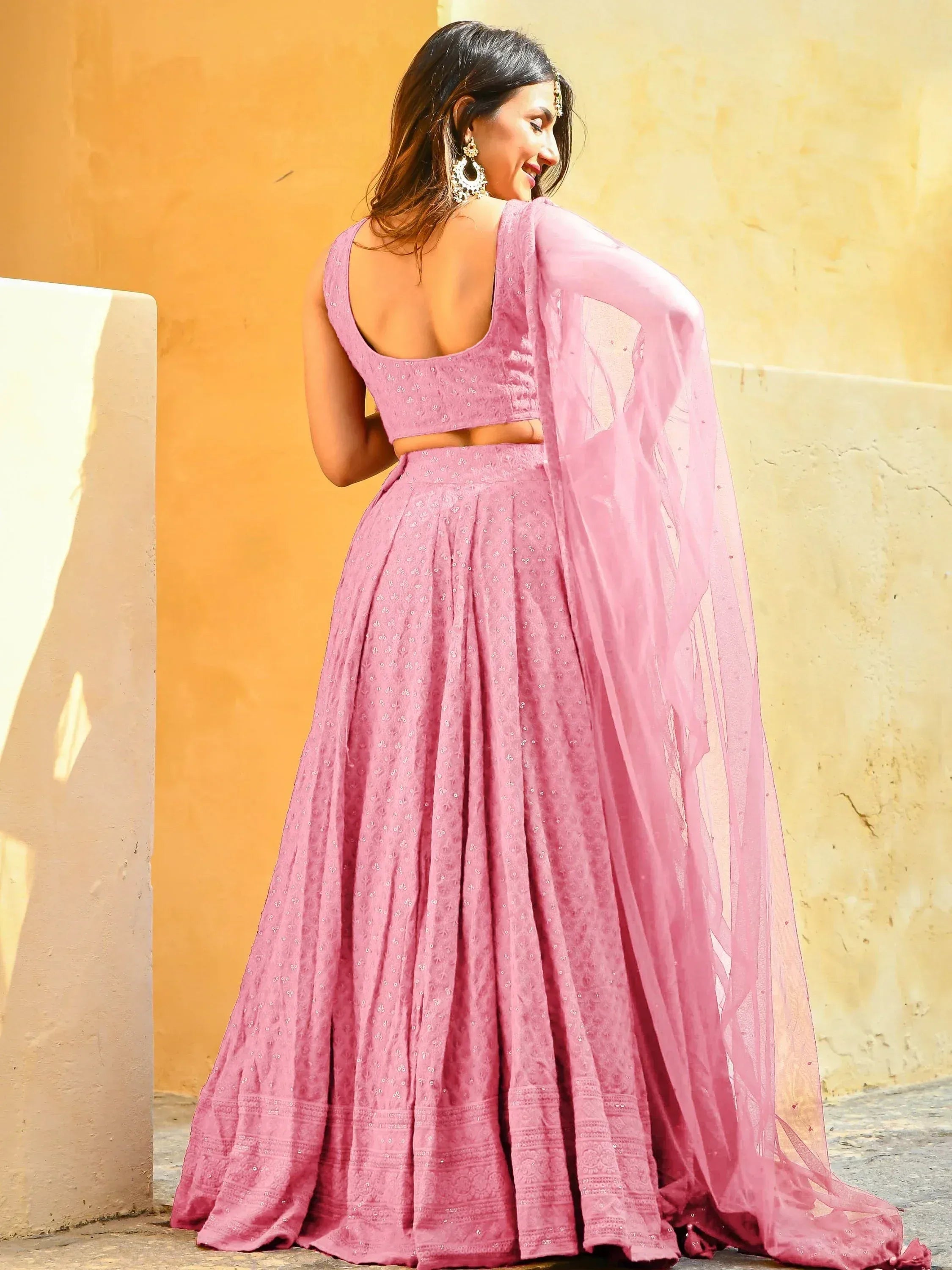Pink designer lehenga choli with backless blouse and sheer dupatta, ethnic Indian wear