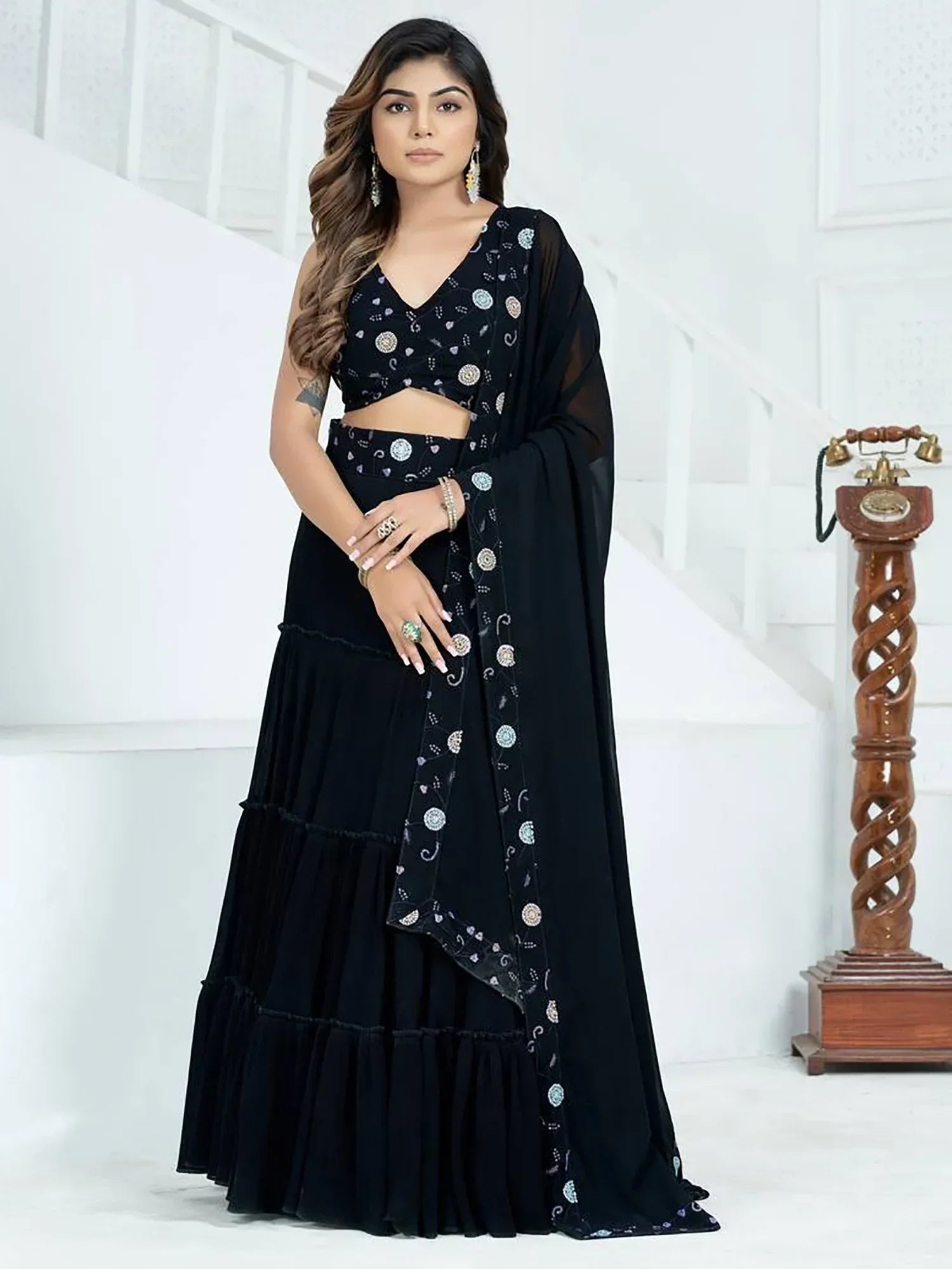 Black embroidered lehenga choli with tiered skirt and sheer dupatta, perfect for Indian ethnic occasions