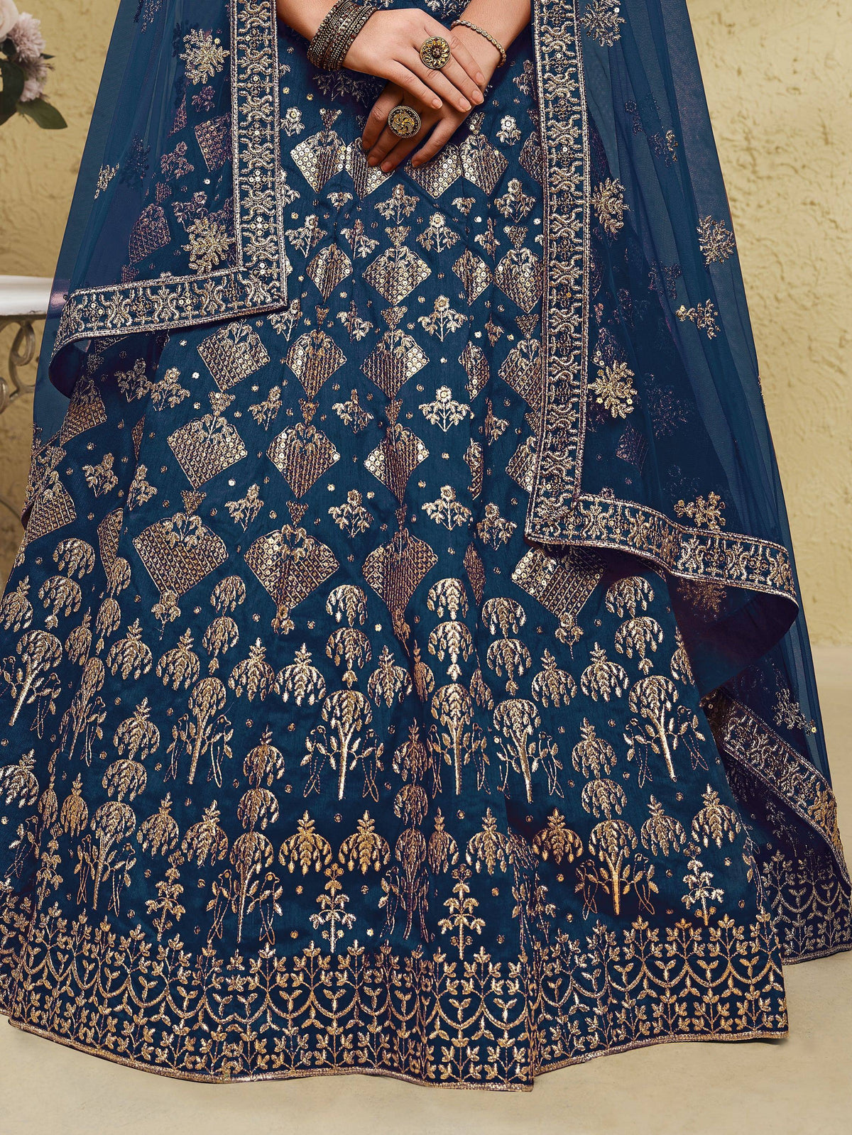 Elegant navy blue lehenga choli with gold floral embroidery and sequin detailing, perfect for Indian ethnic wear.