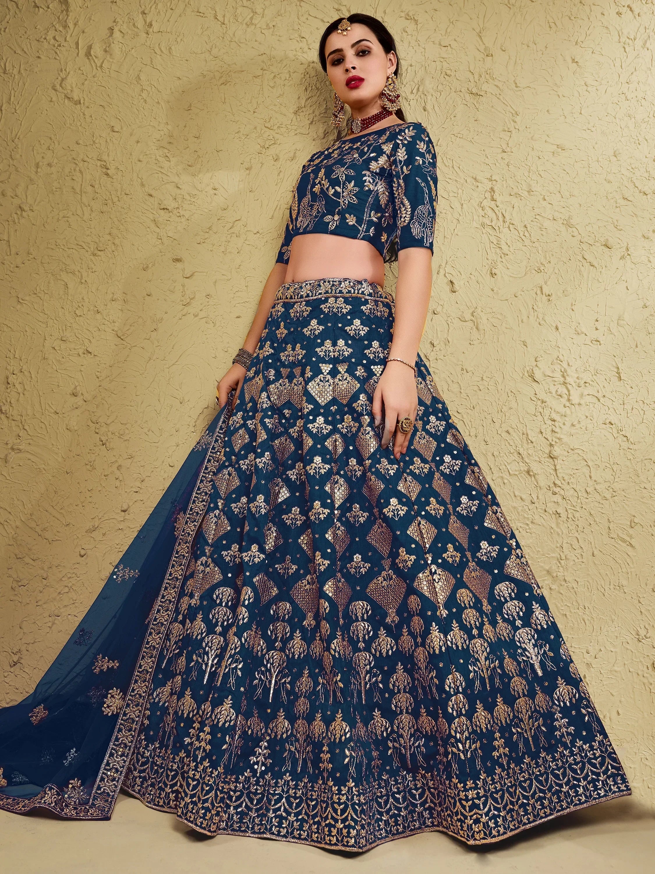 Blue designer lehenga choli with gold embroidery, perfect for Indian ethnic wear and festive occasions.