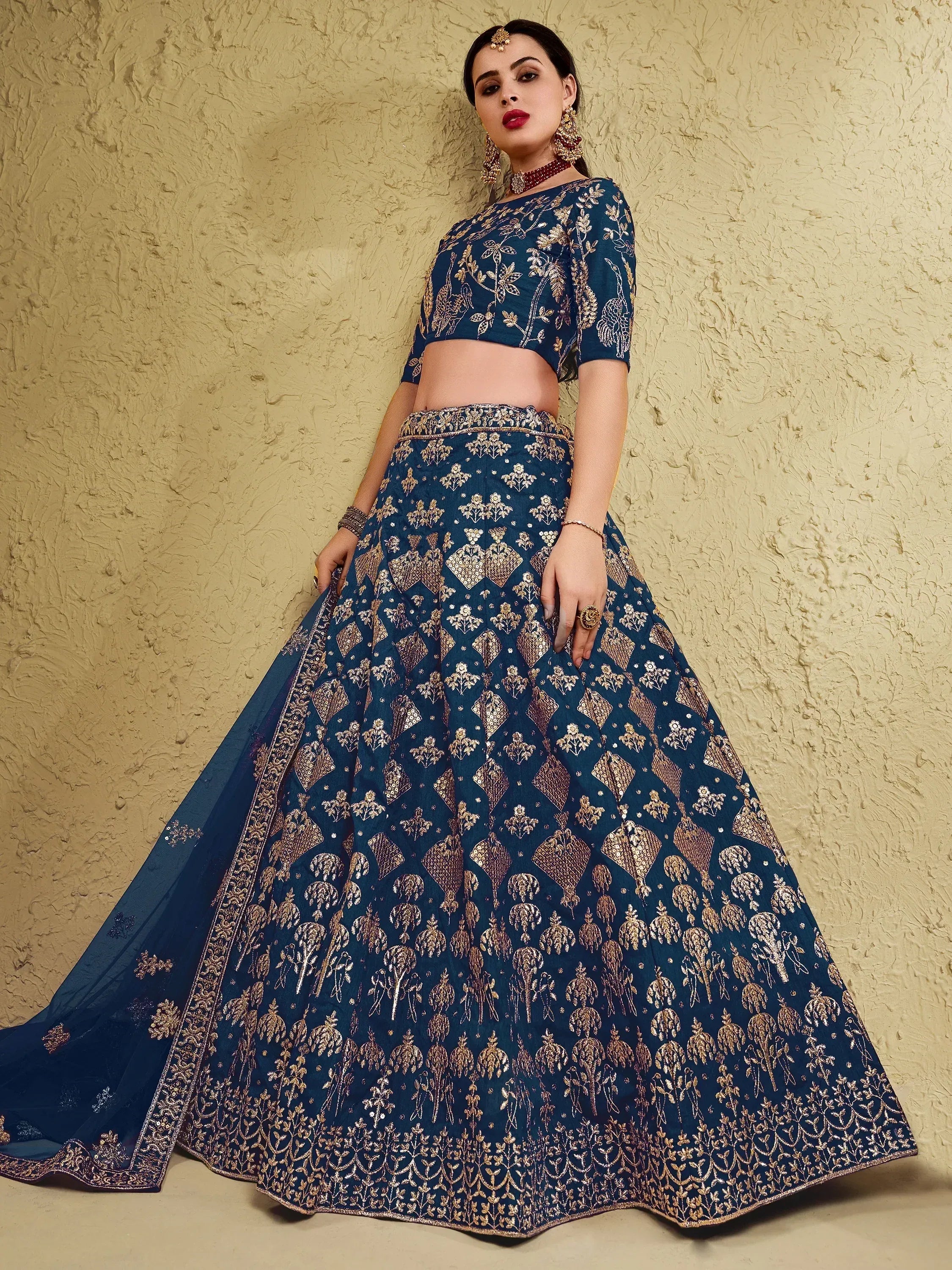 Blue designer lehenga choli with gold embroidery, perfect for Indian ethnic wear and festive occasions.