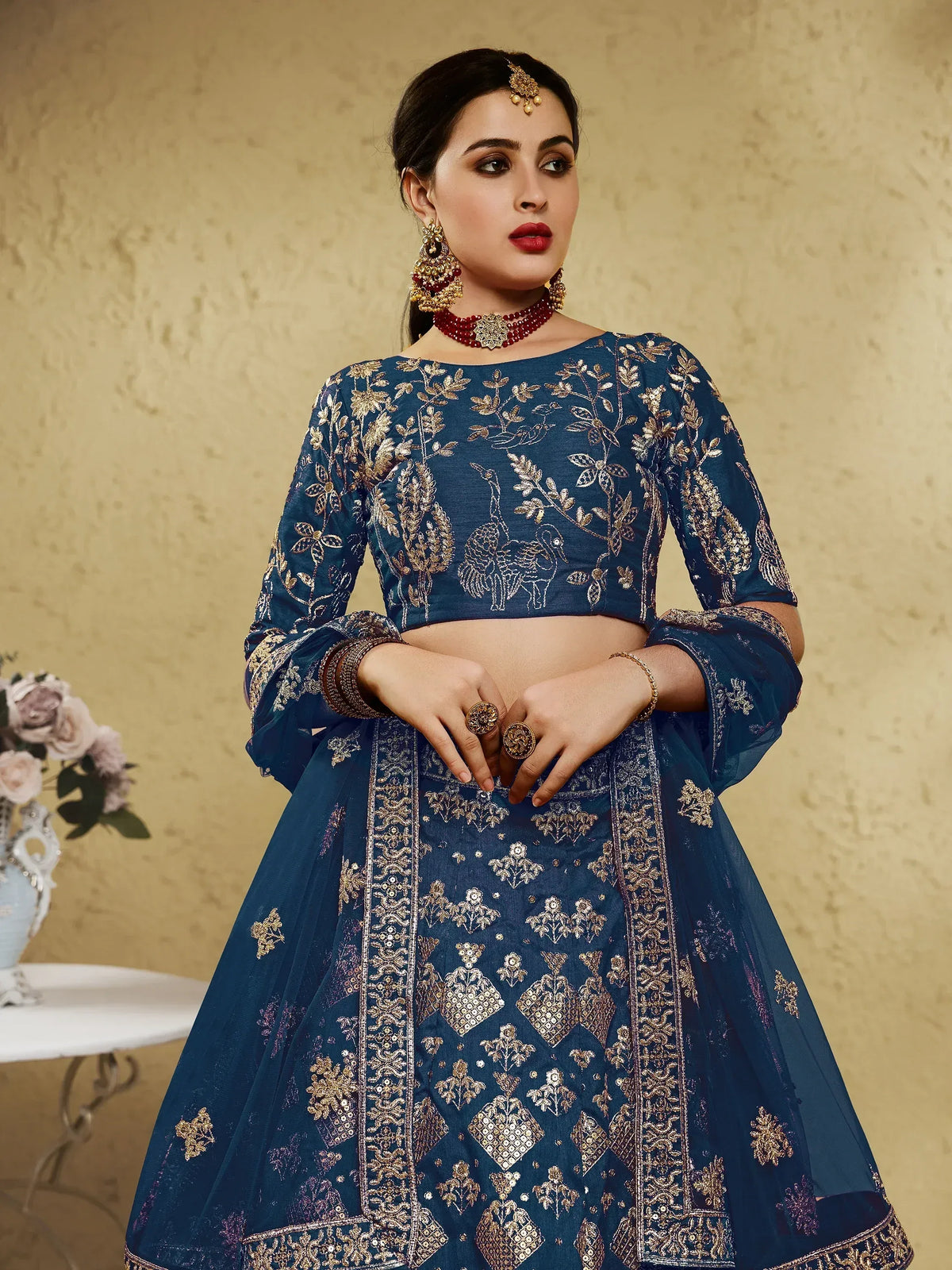 Blue embroidered lehenga choli with gold peacock motifs, perfect for Indian ethnic wear occasions