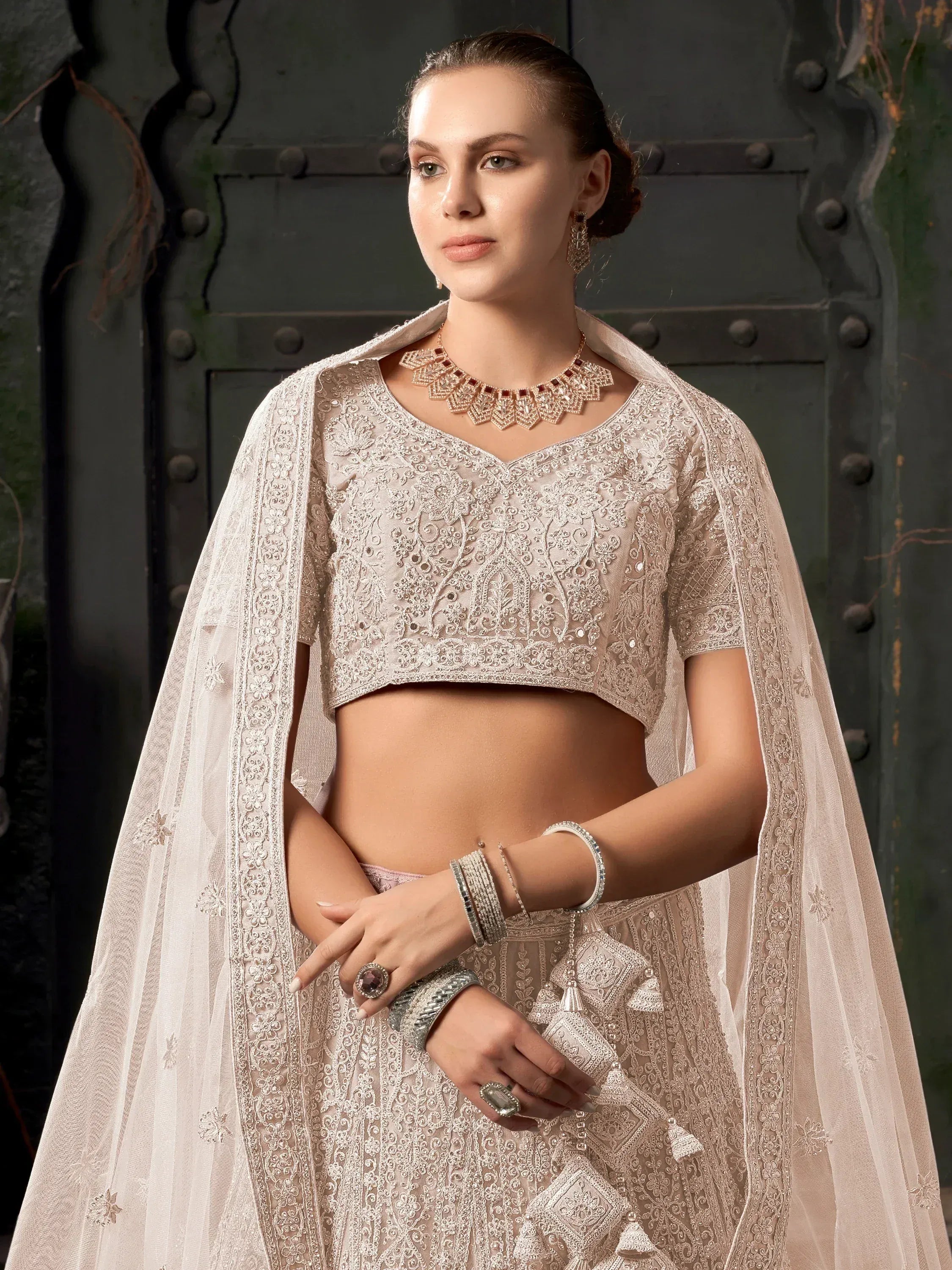 Elegant beige embroidered lehenga choli with sheer cape, perfect for Indian ethnic wear occasions