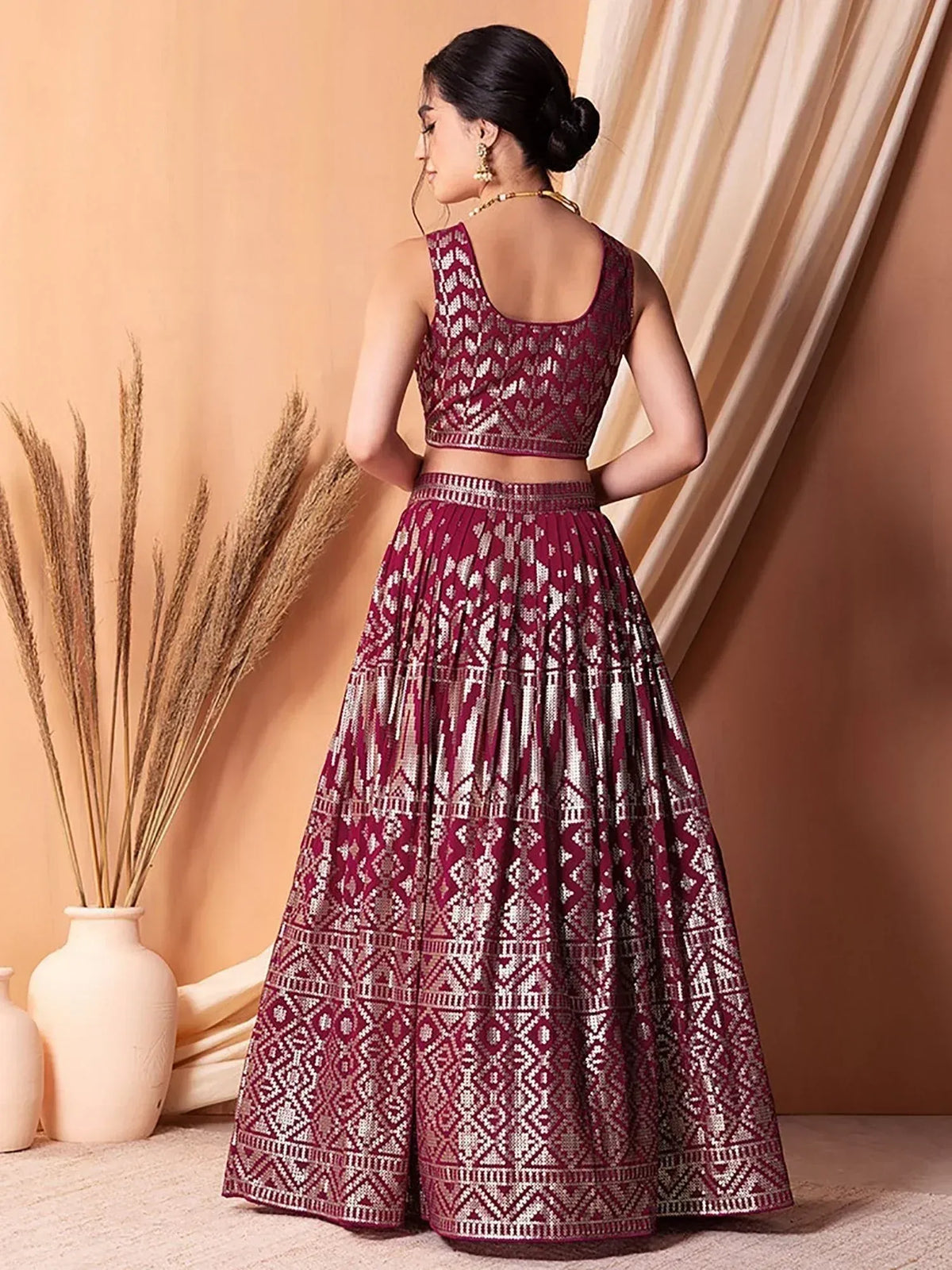 Maroon and gold embroidered lehenga choli with geometric patterns, perfect for Indian ethnic occasions