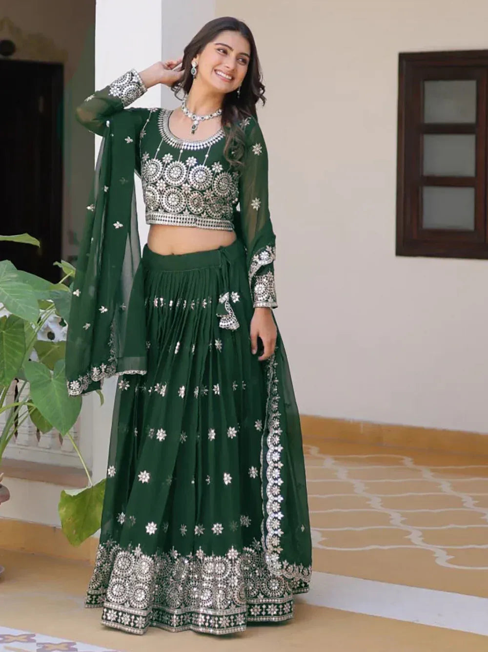 Emerald green embroidered lehenga choli with mirror work, perfect for Indian ethnic wear and festive occasions.