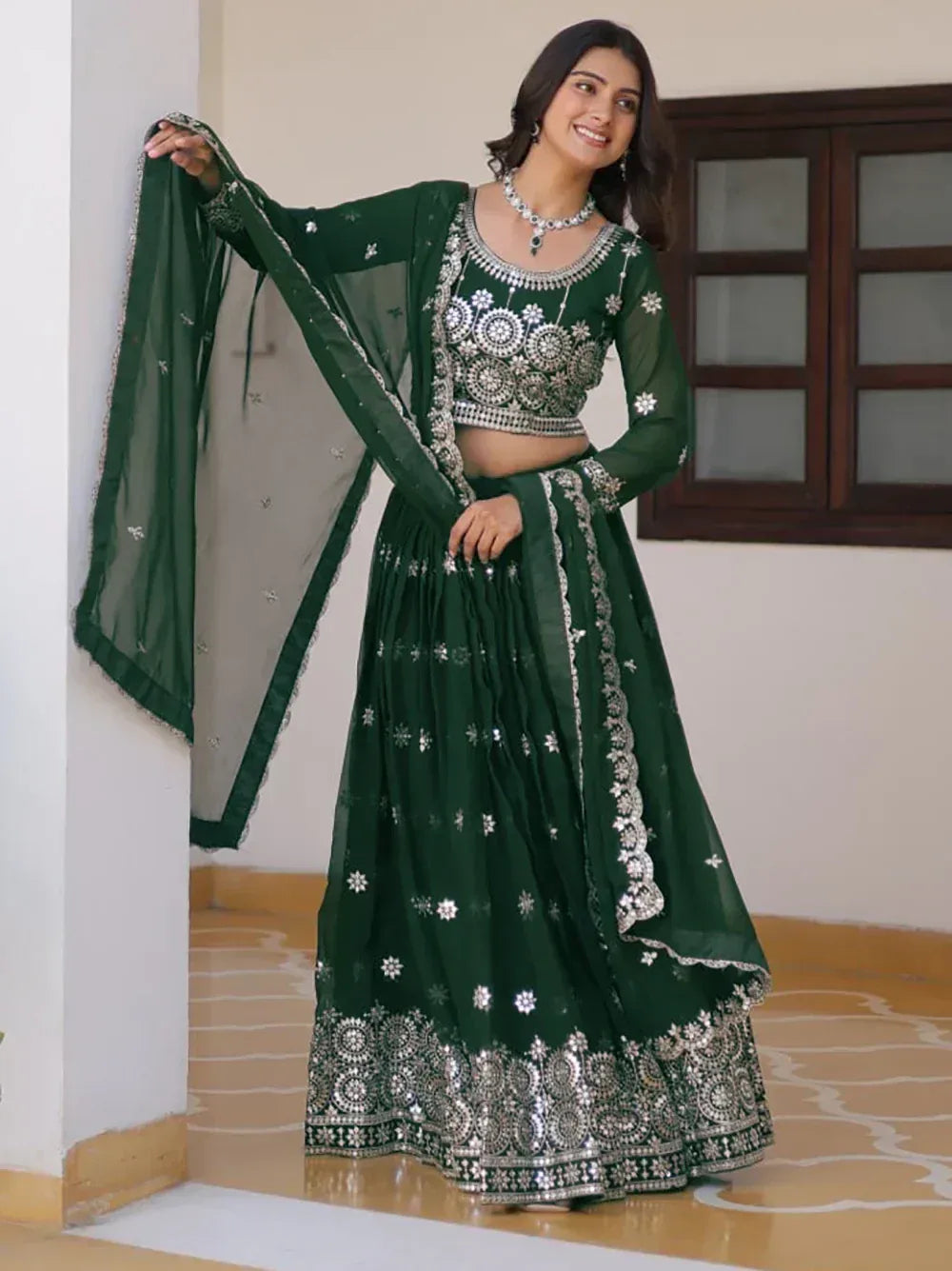 Emerald green lehenga choli with silver embroidery and mirror work, perfect for Indian ethnic occasions