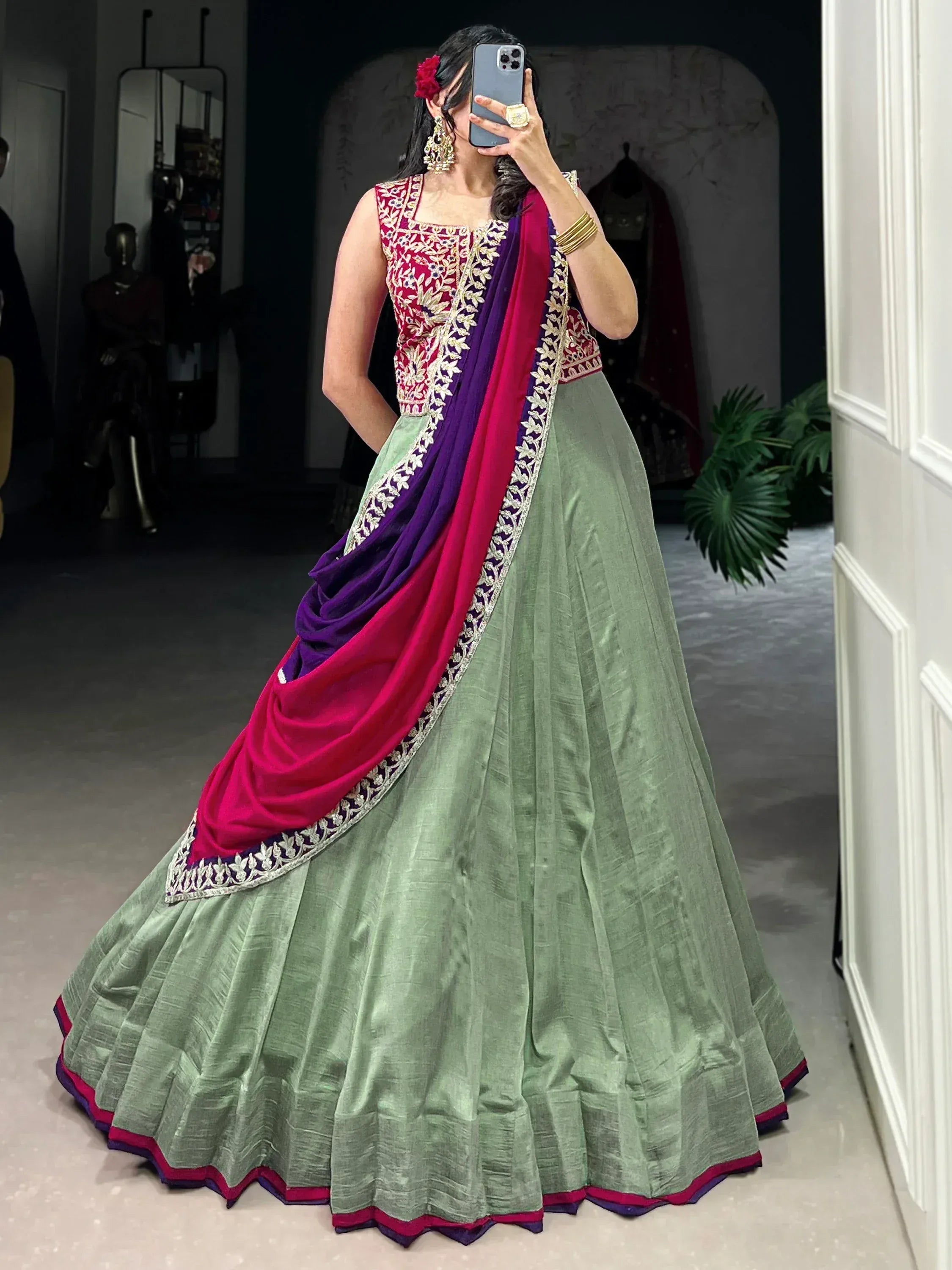 Woman in green lehenga with pink and purple dupatta, floral embroidery, ethnic wear