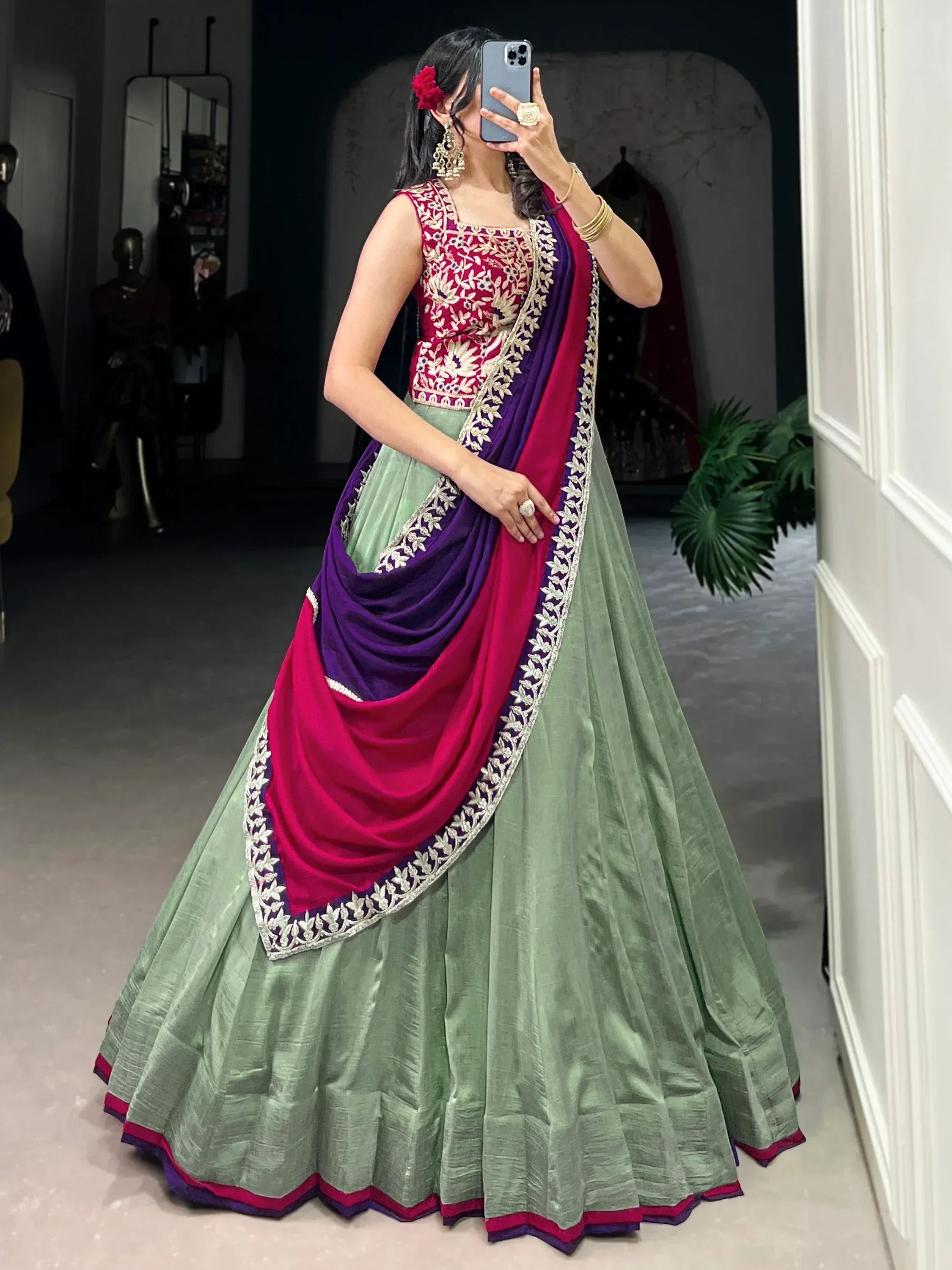 Woman in green lehenga with maroon and purple dupatta, floral embroidery, Indian ethnic wear