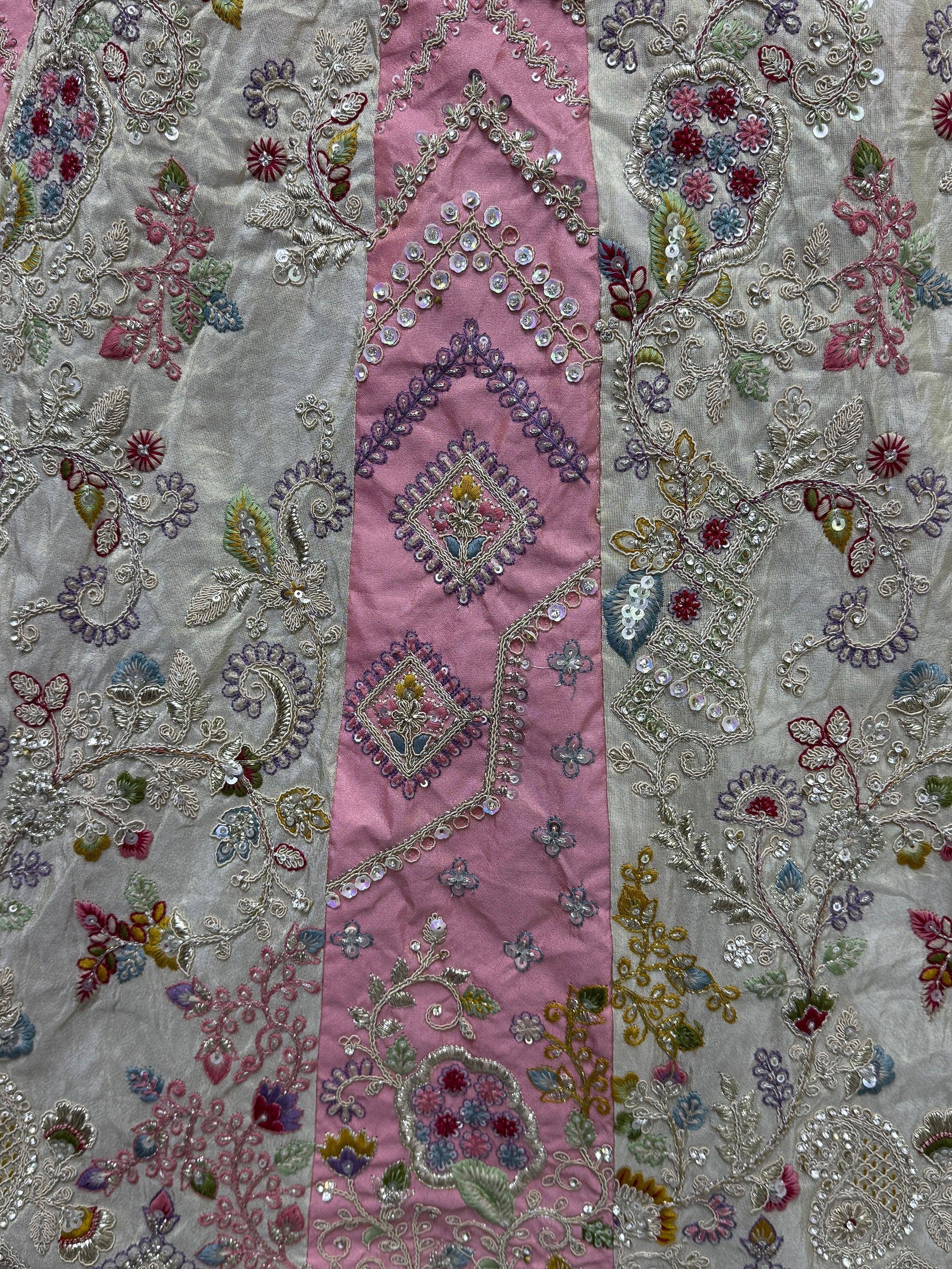 Intricate floral embroidery with sequins on pink and beige Indian ethnic wear fabric