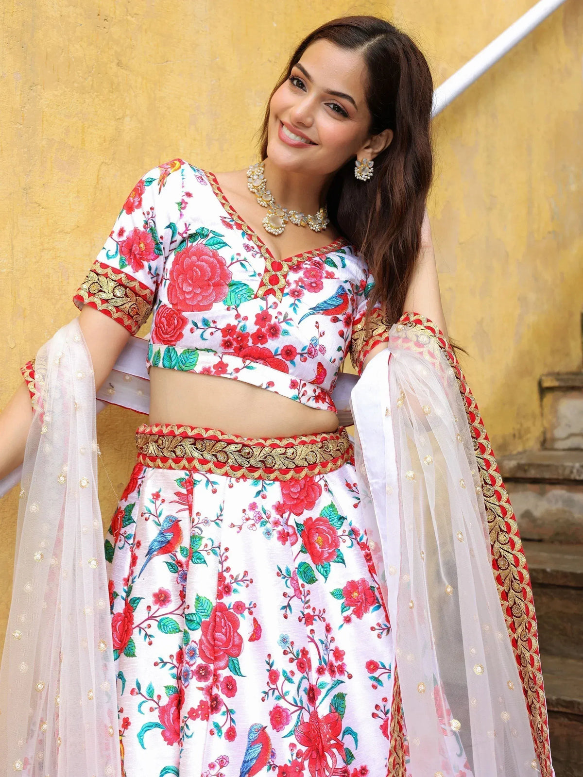 White floral lehenga choli with red and gold embroidery, perfect for Indian ethnic wear occasions