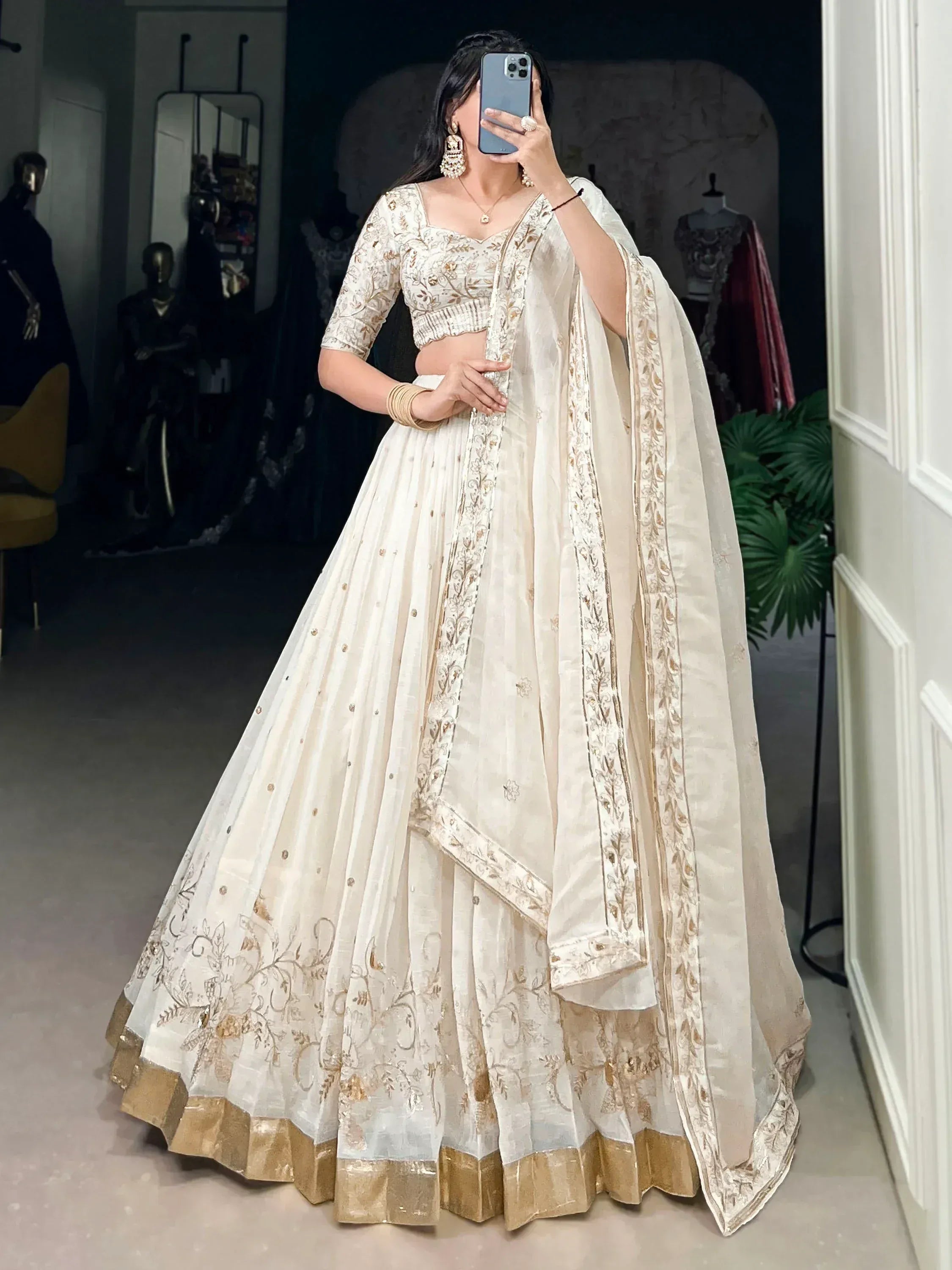 Elegant ivory lehenga choli with gold embroidery, perfect for Indian weddings and festive occasions.