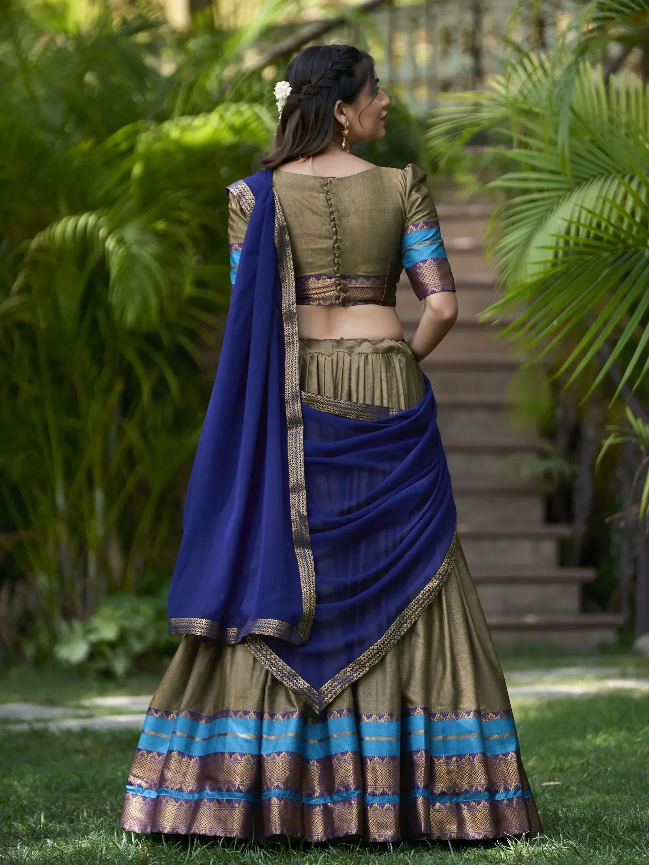 Woman in olive green lehenga choli with blue dupatta, ethnic Indian wear for festive occasions