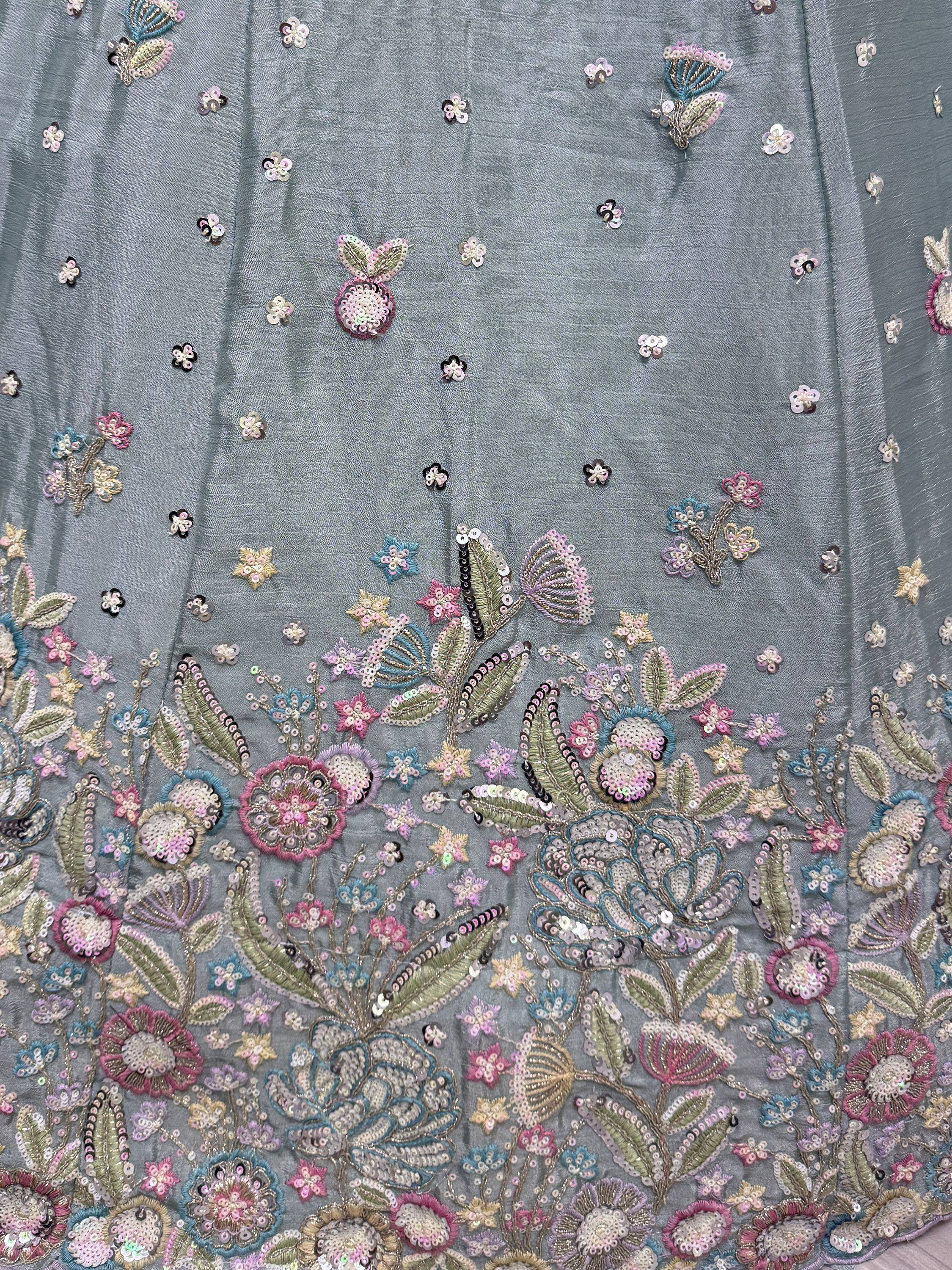 Grey ethnic gown with floral sequin embroidery and pastel accents, perfect for Indian celebrations.