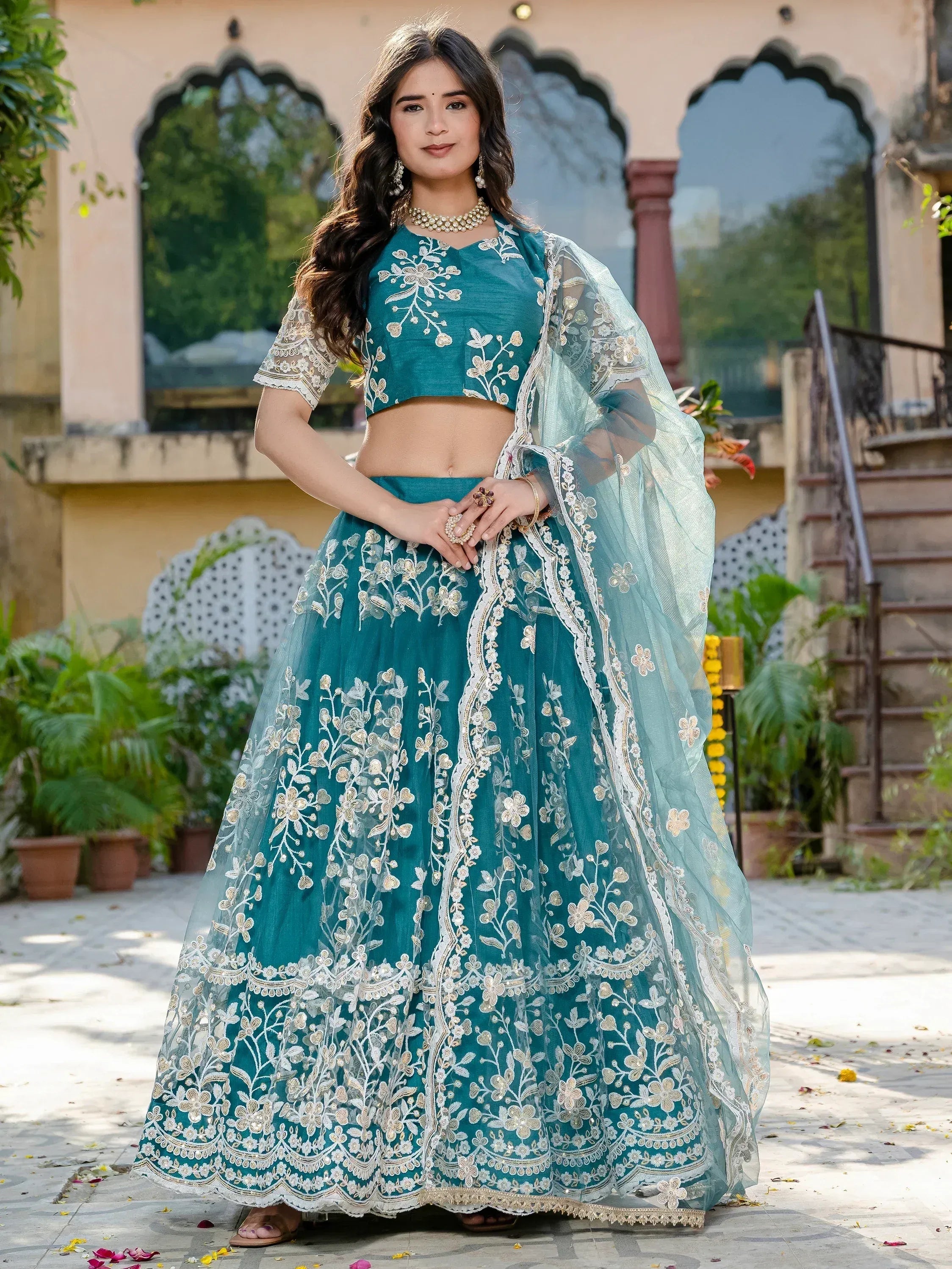 Teal embroidered lehenga choli with floral motifs and sheer dupatta, perfect for Indian ethnic occasions