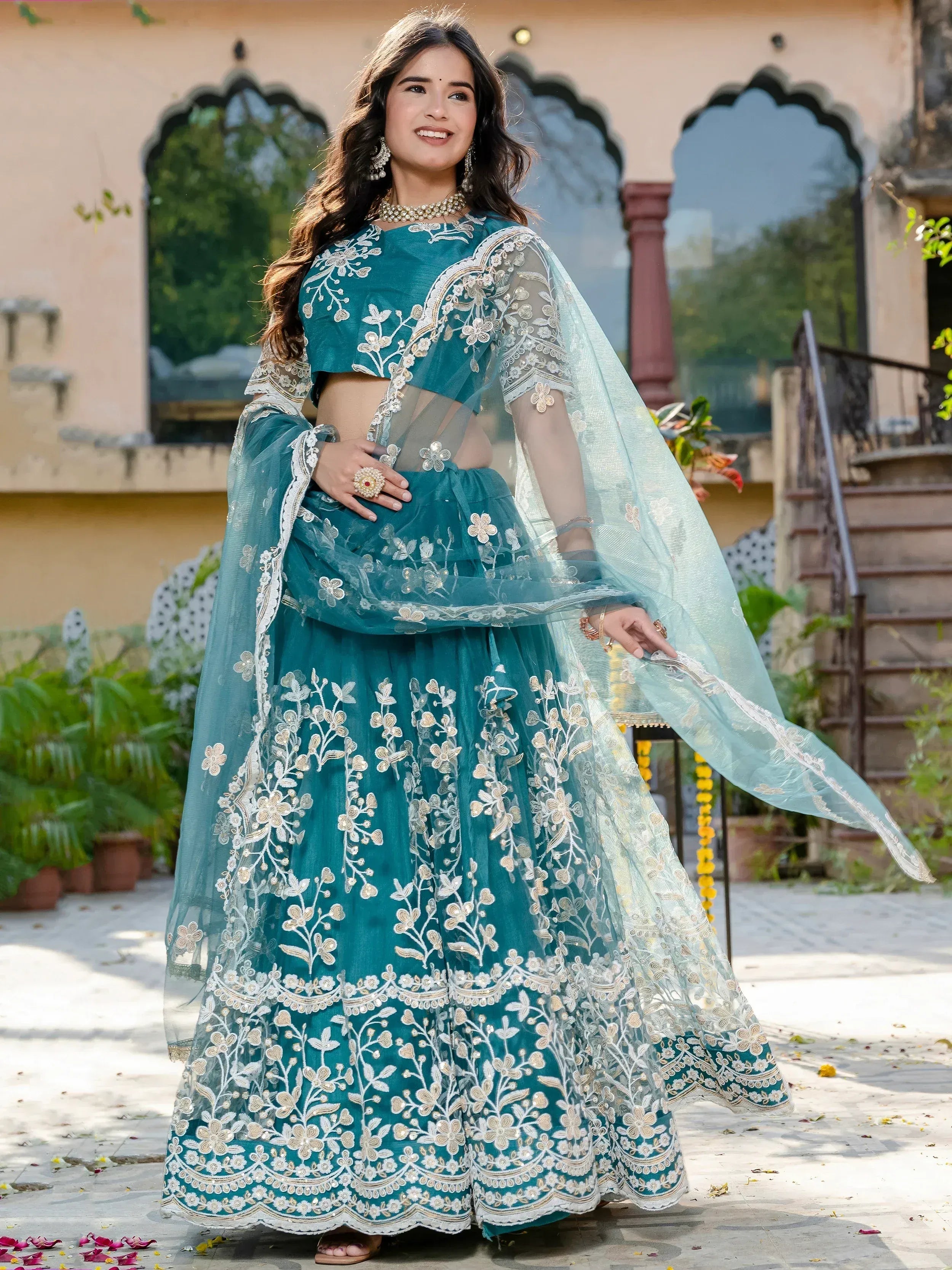 Teal designer lehenga choli with floral embroidery and sheer dupatta for Indian ethnic wear