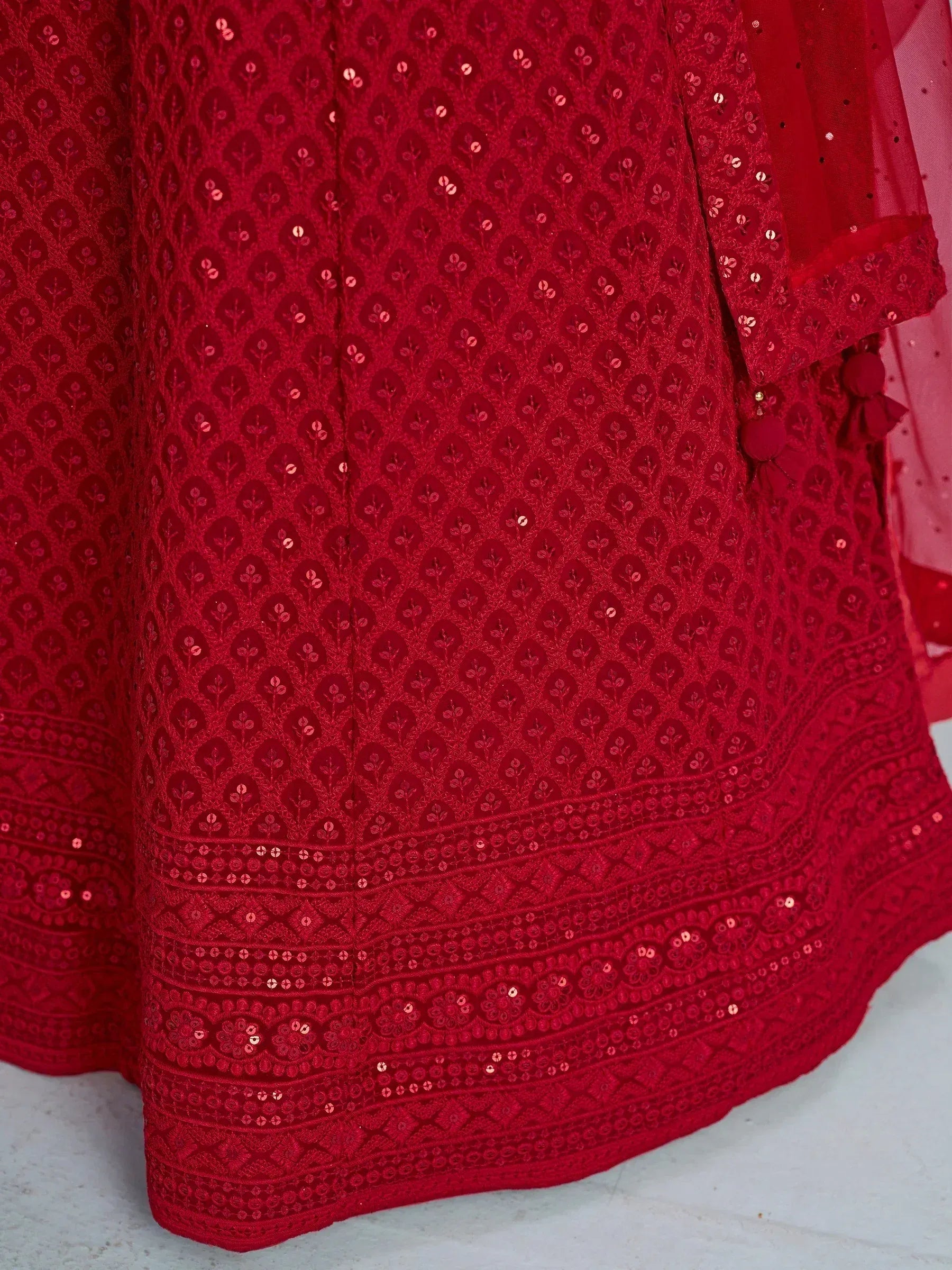 Red ethnic gown with floral embroidery and sequin detailing, perfect for Indian festive occasions