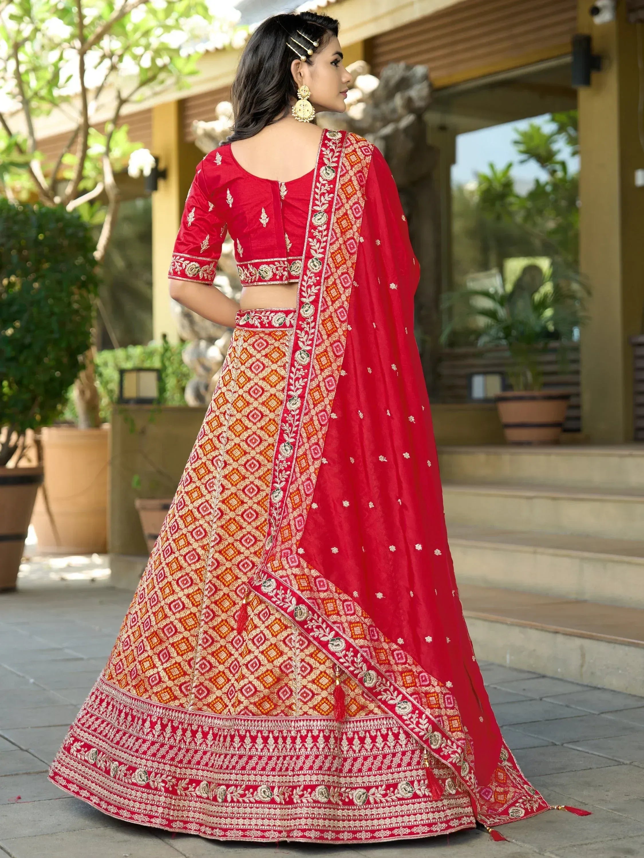 Red embroidered lehenga choli with geometric patterns, perfect for Indian ethnic wear and festive occasions.