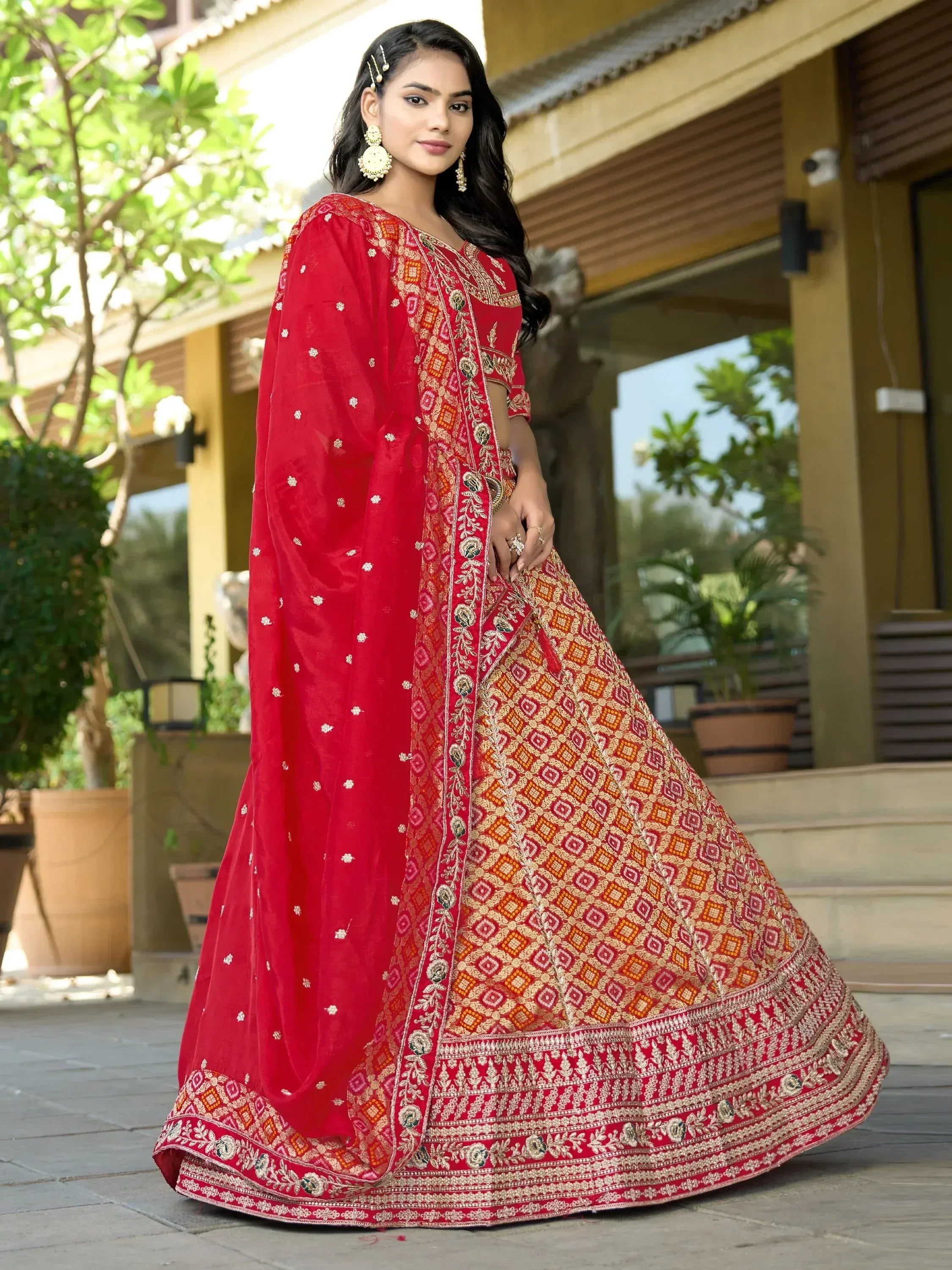 Red embroidered lehenga choli with gold patterns, perfect for Indian ethnic wear and festive occasions.