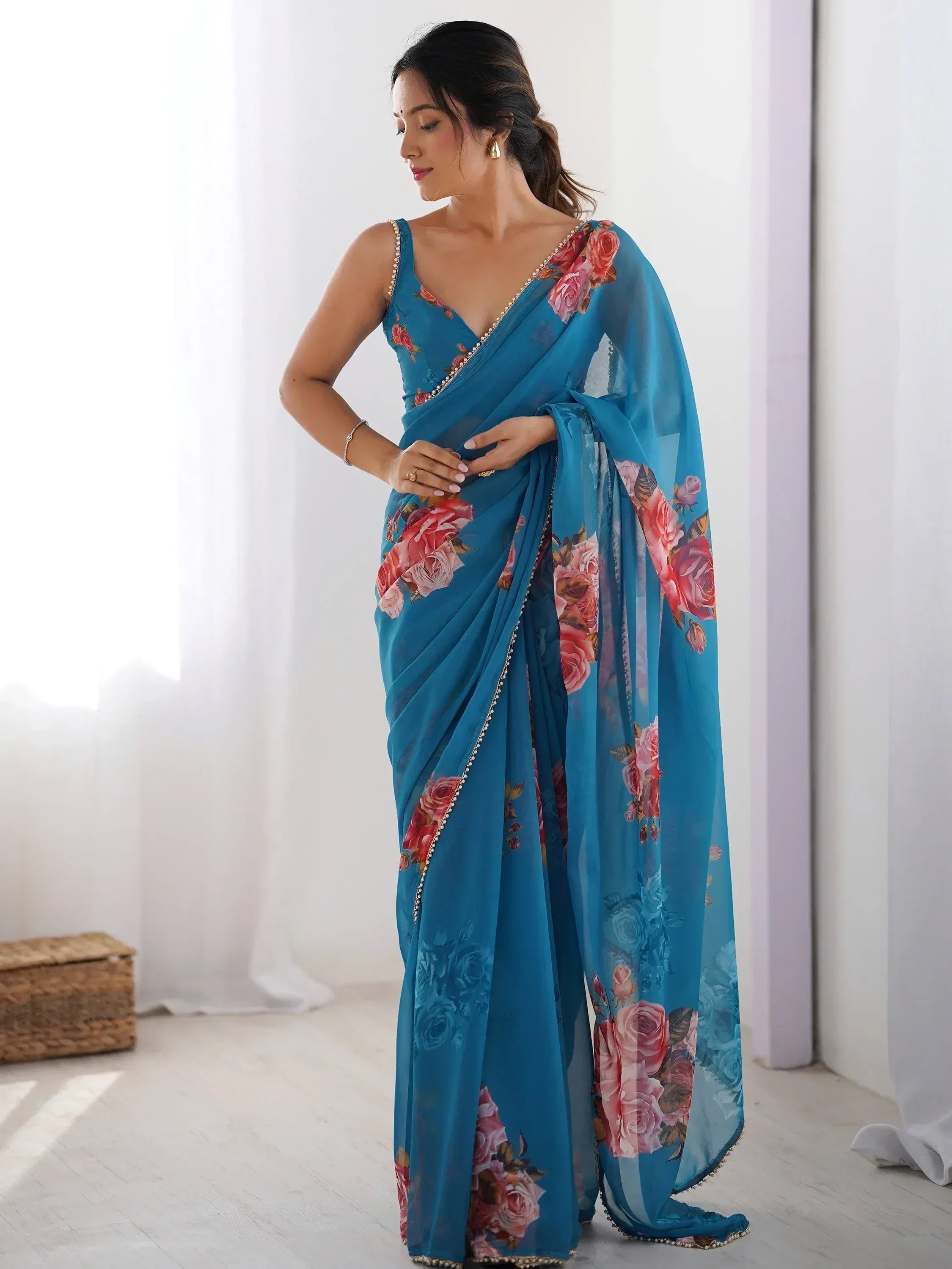 Teal floral saree with pearl trim, elegant Indian ethnic wear for women